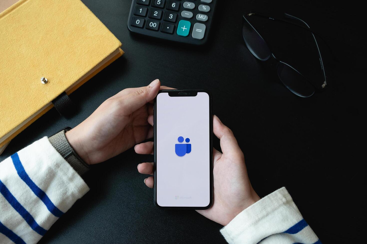 CHIANG MAI,THAILAND - APR 06, 2020 . A working from home employee is downloading the Microsoft Teams social platform, photo
