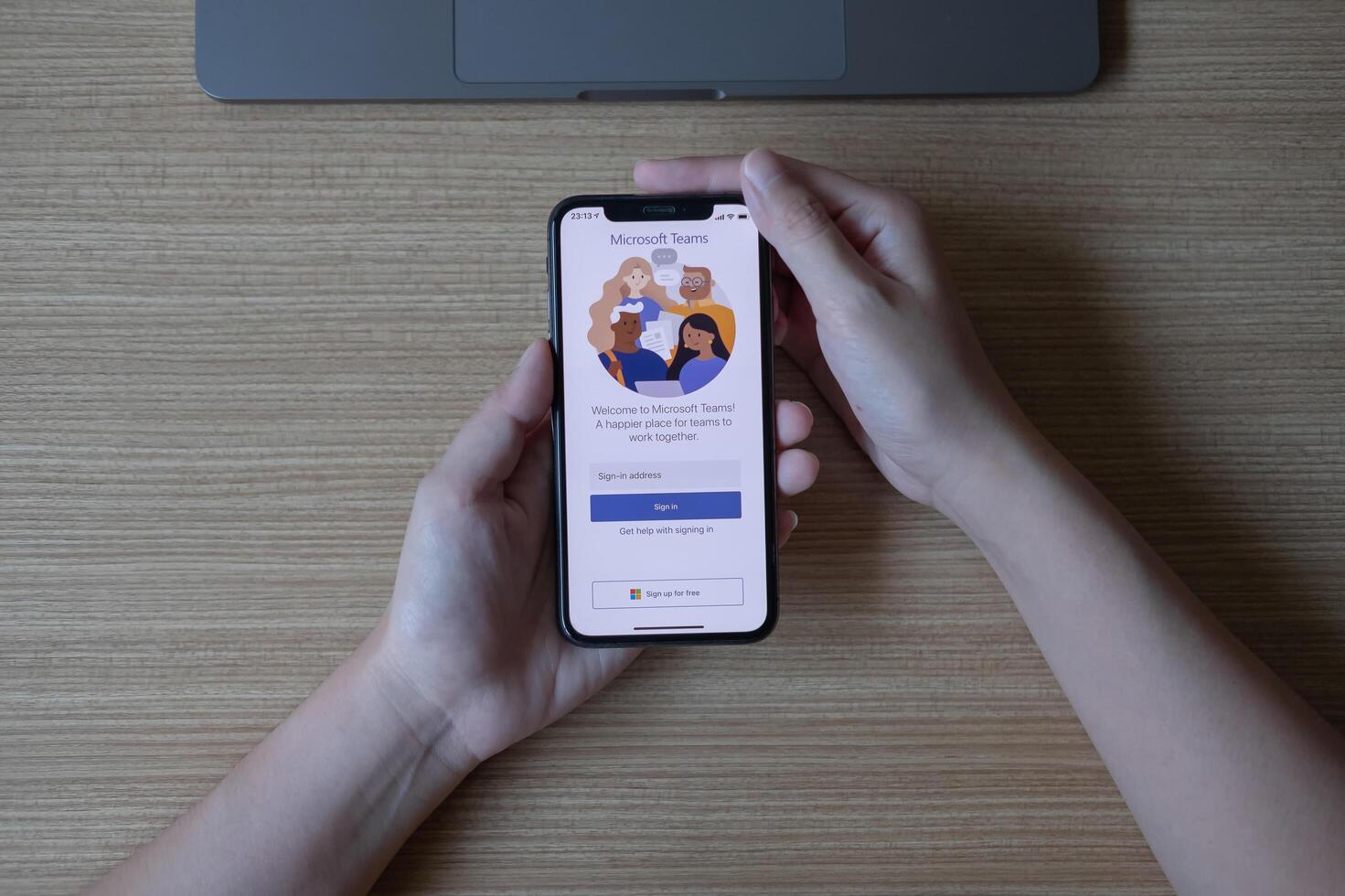 CHIANG MAI, THAILAND - JUN 22, 2020 . female touching iPhone with LinkedIn screen. LinkedIn helps build resume and look for a new job photo
