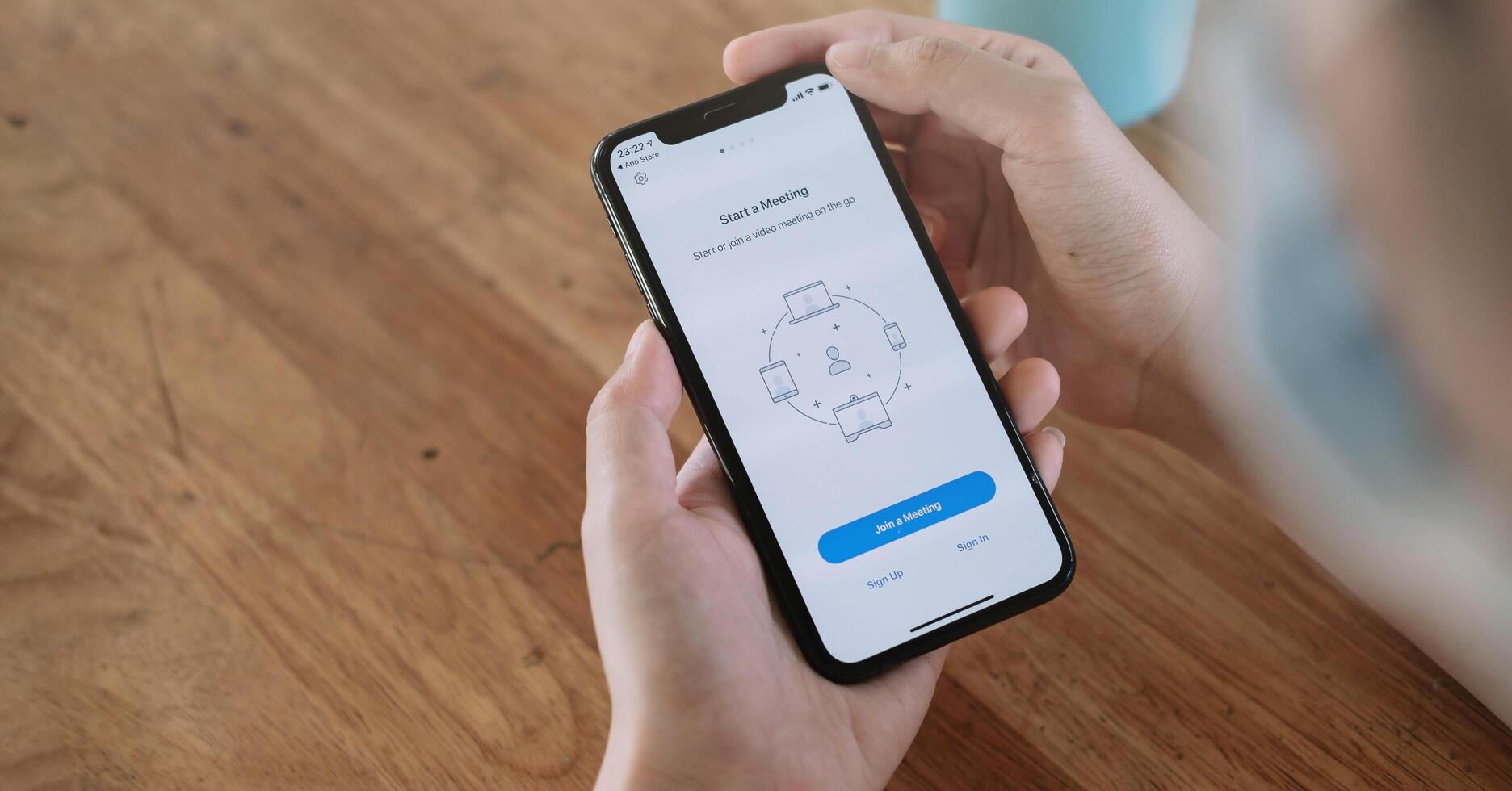 CHIANG MAI, THAILAND - JUN 14, 2020 . A working from home employee is downloading the Zoom application social platform, ready for internet meetings, remote workers or online education photo
