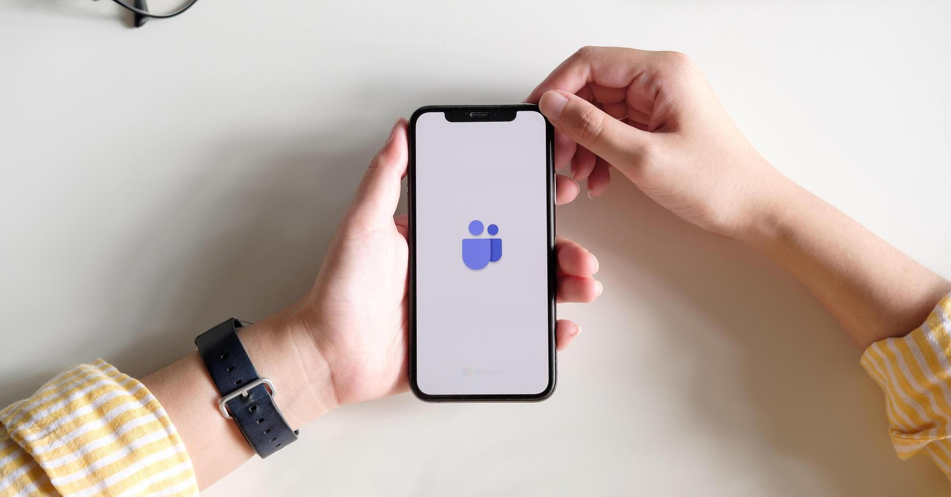 CHIANG MAI, THAILAND - JULY 3, 2020 . A working from home employee is downloading the Microsoft Teams social platform, ready for remote working in isolation from home. photo