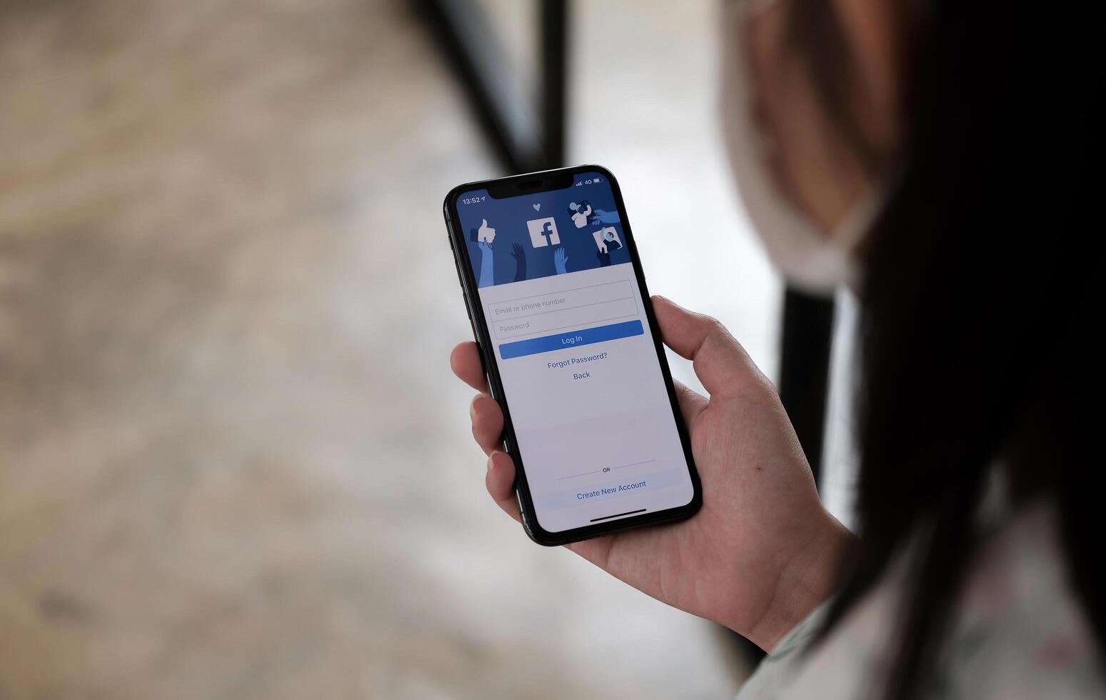 CHIANG MAI, THAILAND - NOV 14, 2021. Facebook social media app logo on log-in, sign-up registration page on mobile app screen on iPhone X in person's hand working on e-commerce shopping business photo