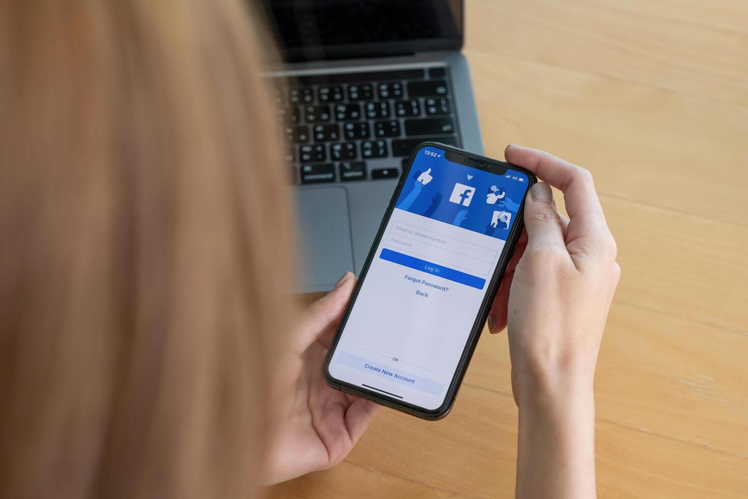 CHIANG MAI, THAILAND - OCT 03, 2018. Facebook social media app logo on log-in, sign-up registration page on mobile app screen on iPhone X in person's hand working on e-commerce shopping business photo