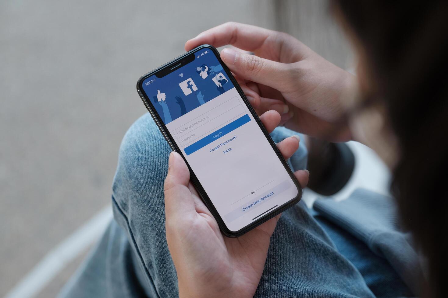 CHIANG MAI, THAILAND - NOV 28, 2021. Facebook social media app logo on log-in, sign-up registration page on mobile app screen on iPhone Xs in person's hand working on e-commerce shopping business. photo