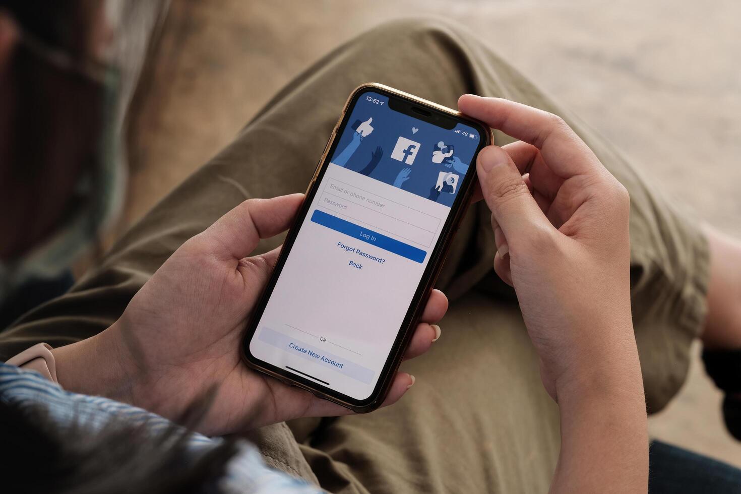 CHIANG MAI, THAILAND - NOV 7, 2021. Facebook social media app logo on log-in, sign-up registration page on mobile app screen on iPhone X in person's hand working on e-commerce shopping business. photo
