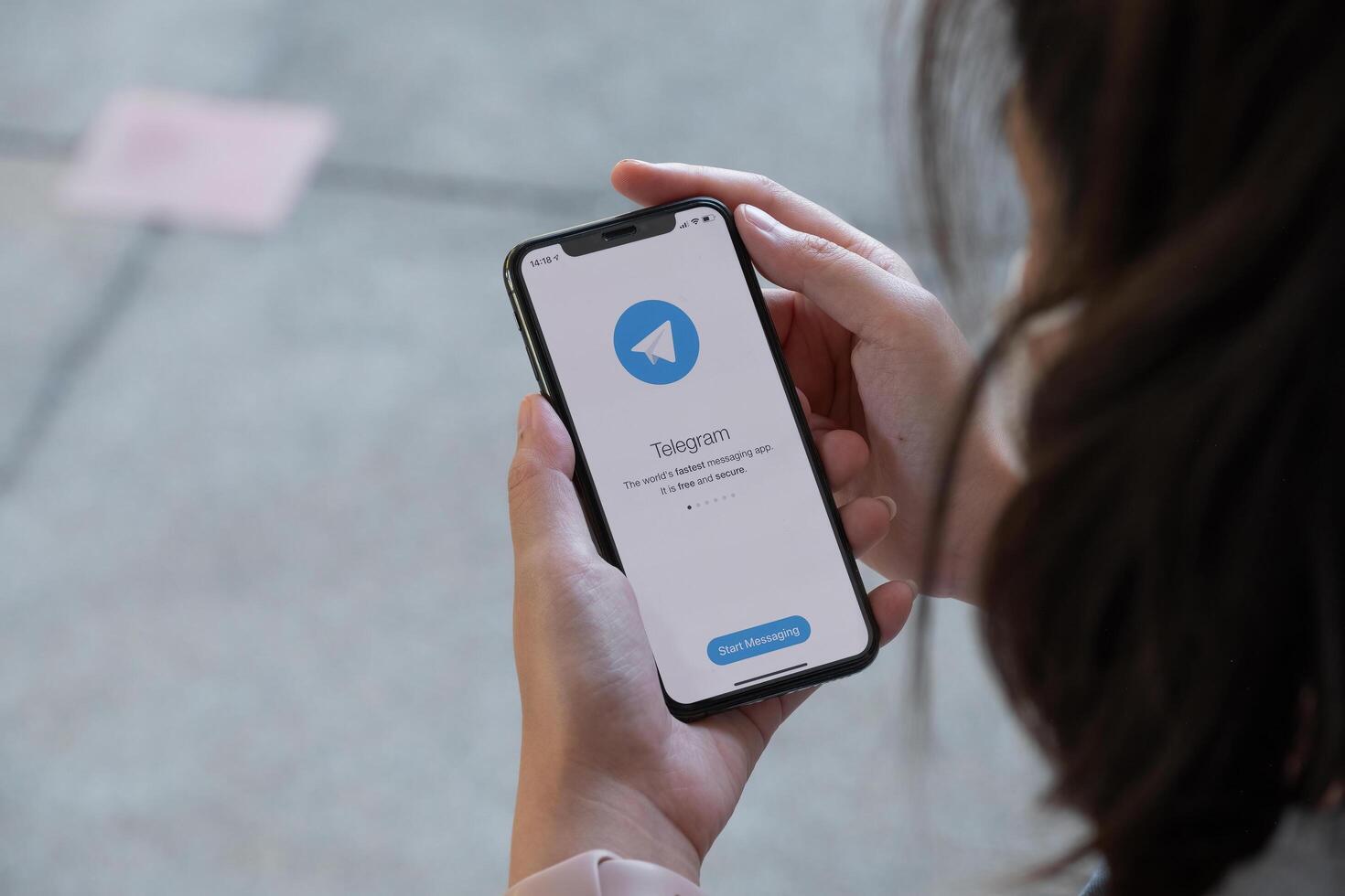 CHIANGMAI ,THAILAND, 28 NOV 2021 . Woman hand holding iPhone xs with social networking service Telegram on the screen photo