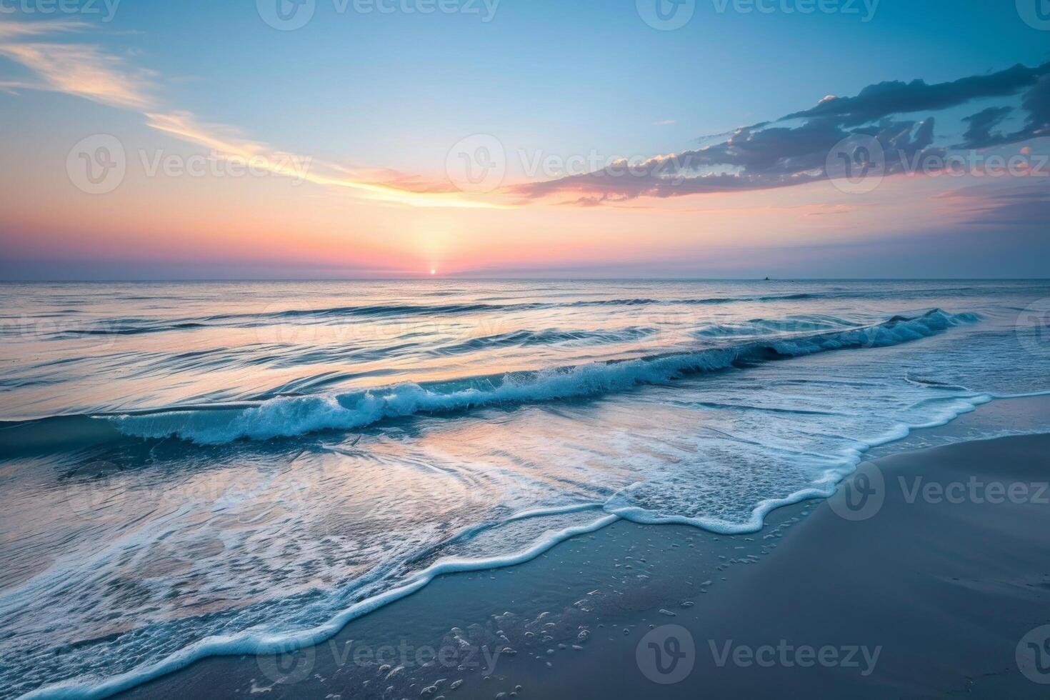 Pastel sunset over calm ocean waves photo