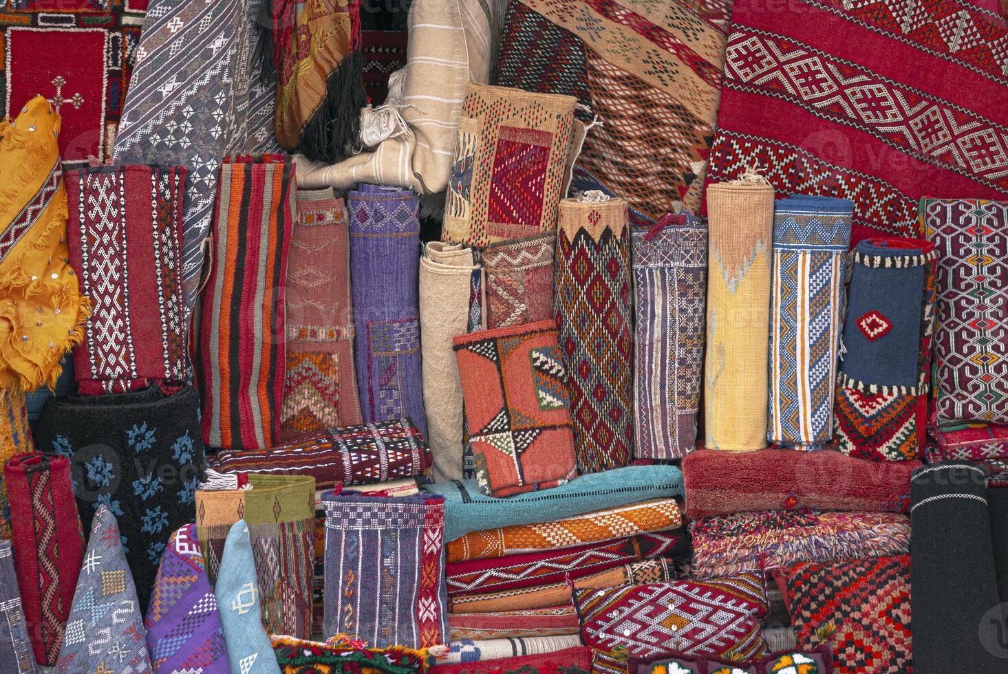 Moroccan carpets and rugs, handwoven by the berber tribes on display. Variety of carpets styles, patterns and colors. photo