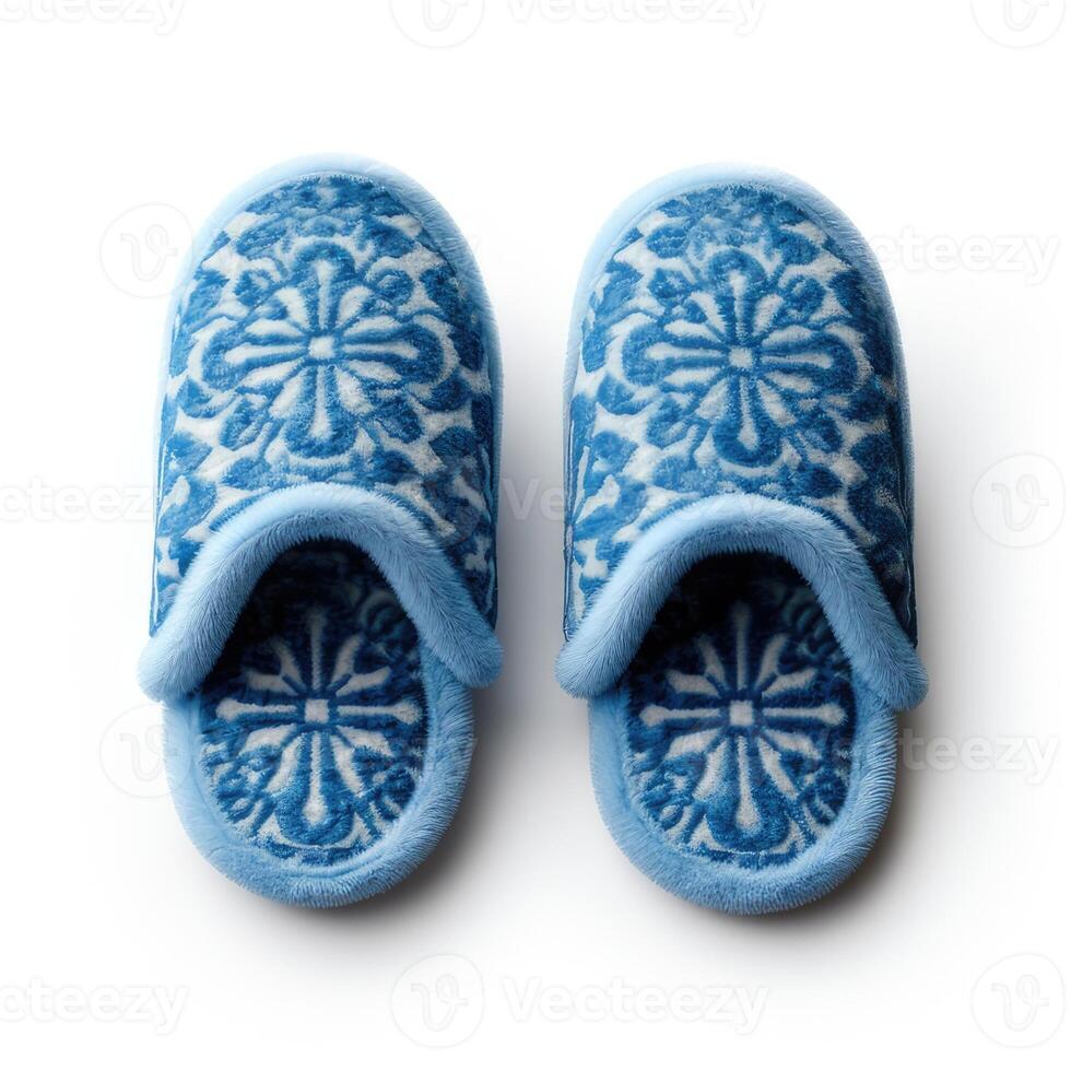 Cozy blue slippers with a pattern and isolated on a white background. Top view photo