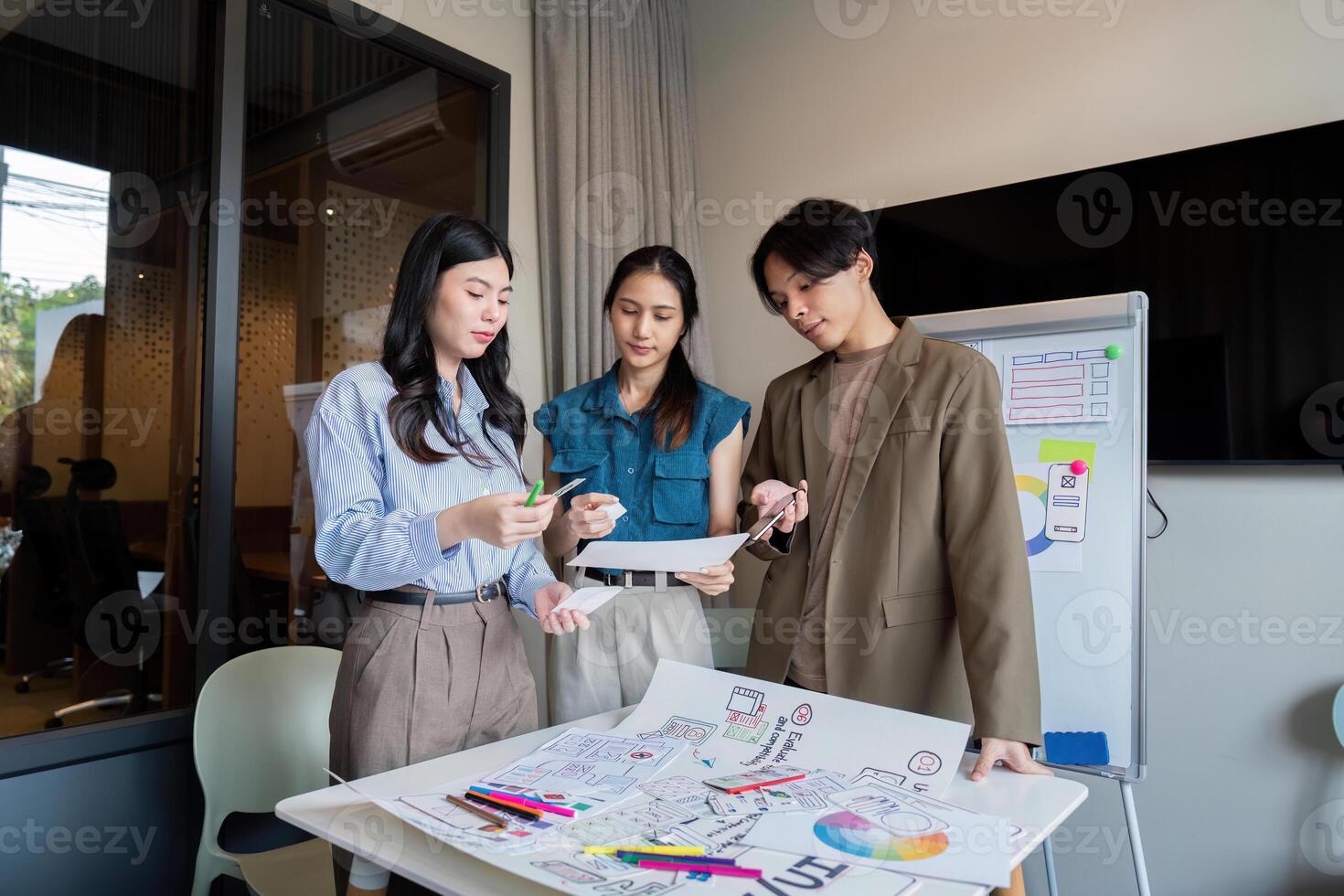 ux developer and ui designer presenting mobile app interface design on whiteboard in meeting at office. Creative digital development mobile app agency. digital transformation photo