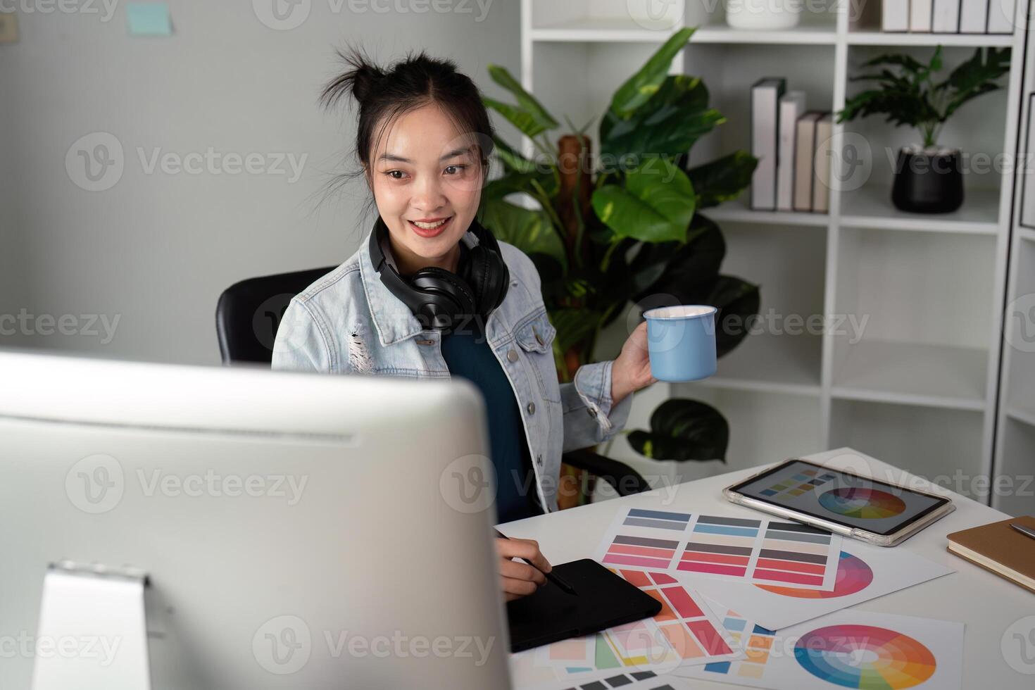UX designer. Work on creative applications. Man with a palette in his hands. Designer applies the primary colors to the monitors. Development of a training application. Designer is a freelancer photo