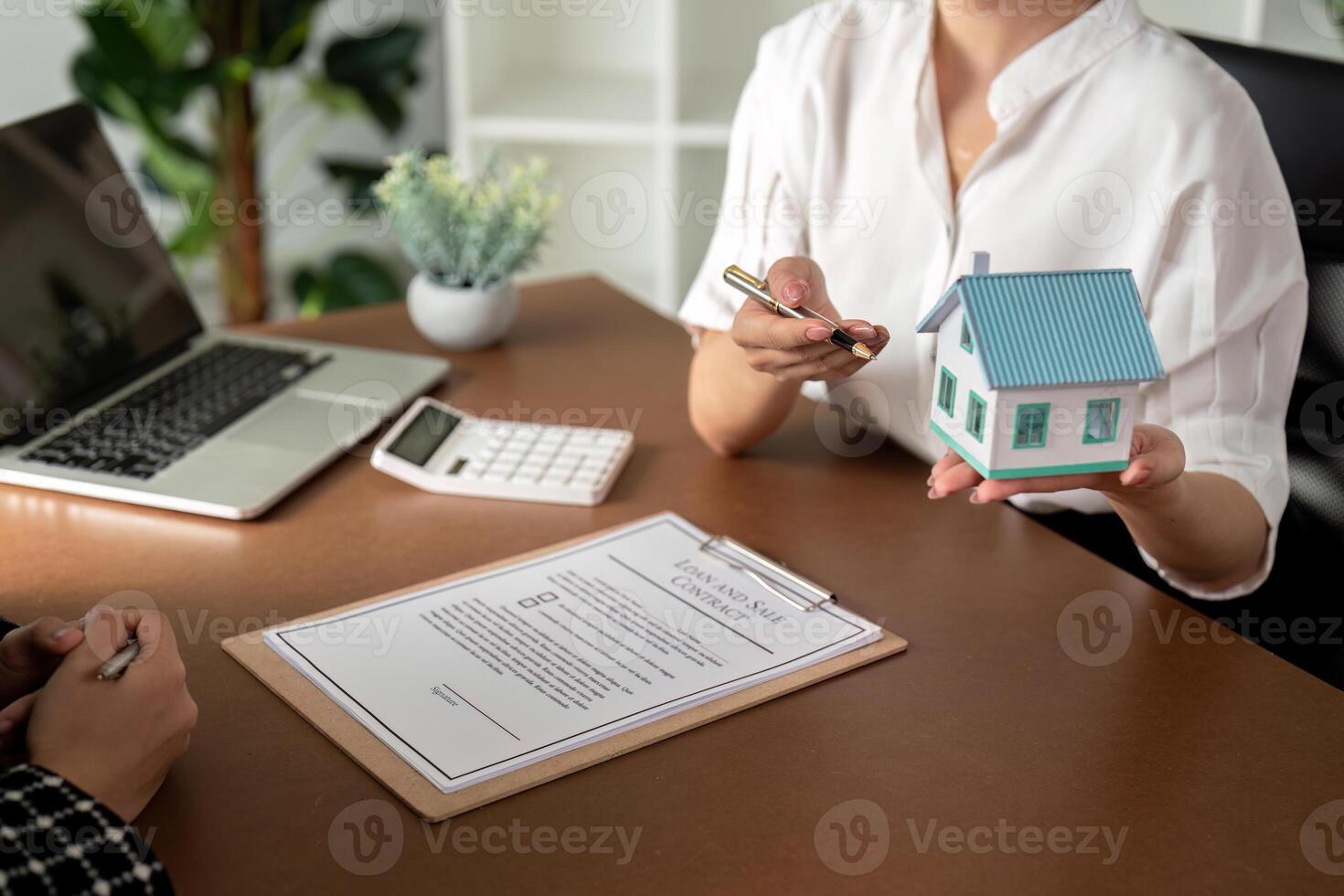 Real estate agent talking about the terms of the home purchase agreement and the customer to signing the documents to make the contract legally, Home sale and home insurance photo