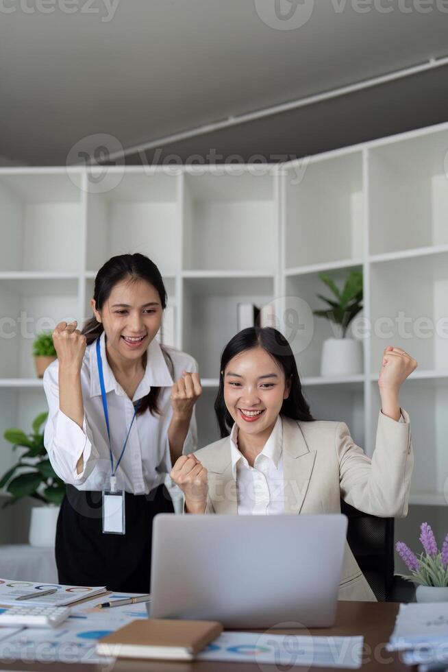 Two businesswomen celebrating success at the office photo