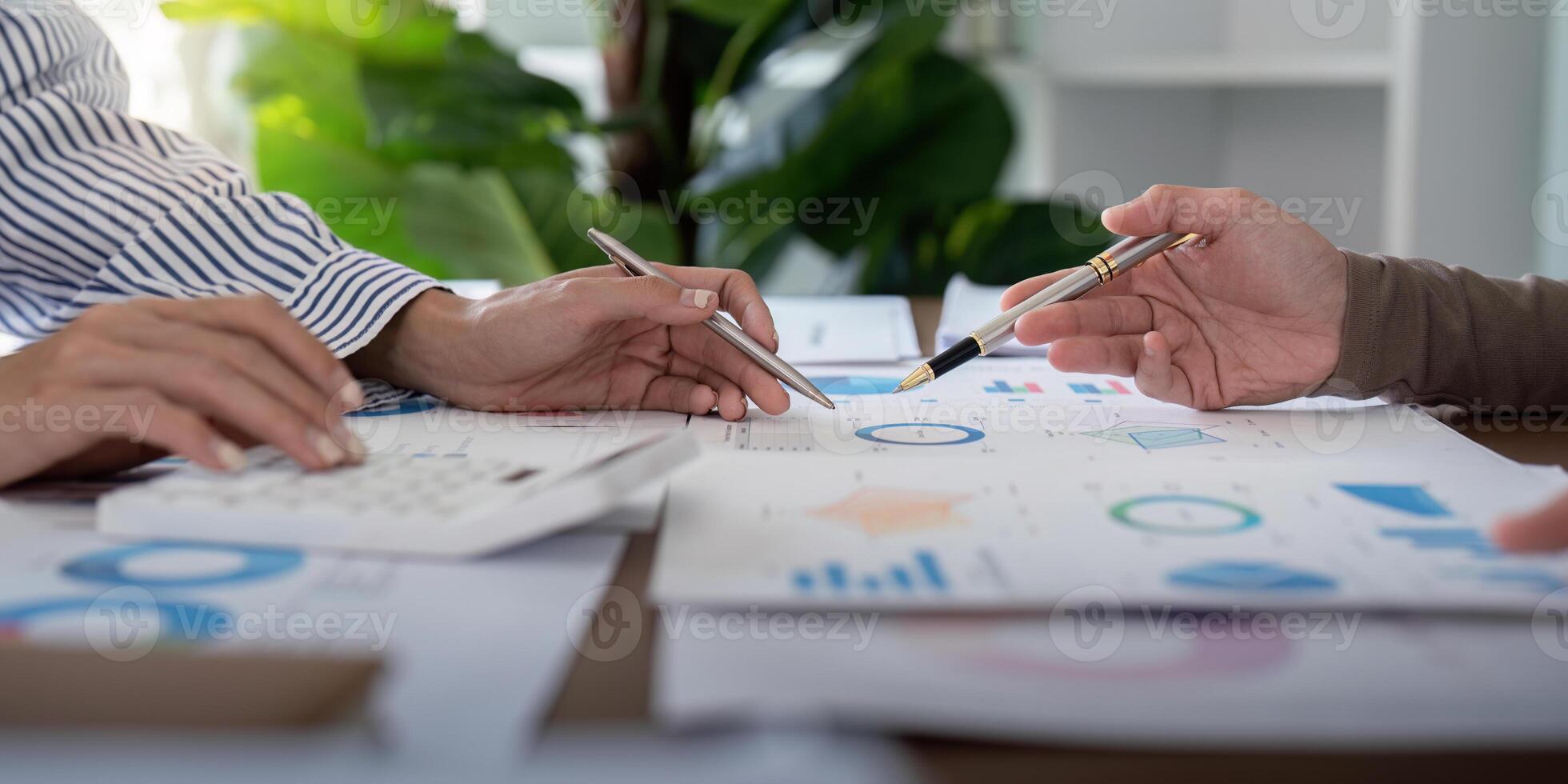 Business professionals analyzing financial charts in a modern office. Concept of teamwork, strategy, and data analysis photo