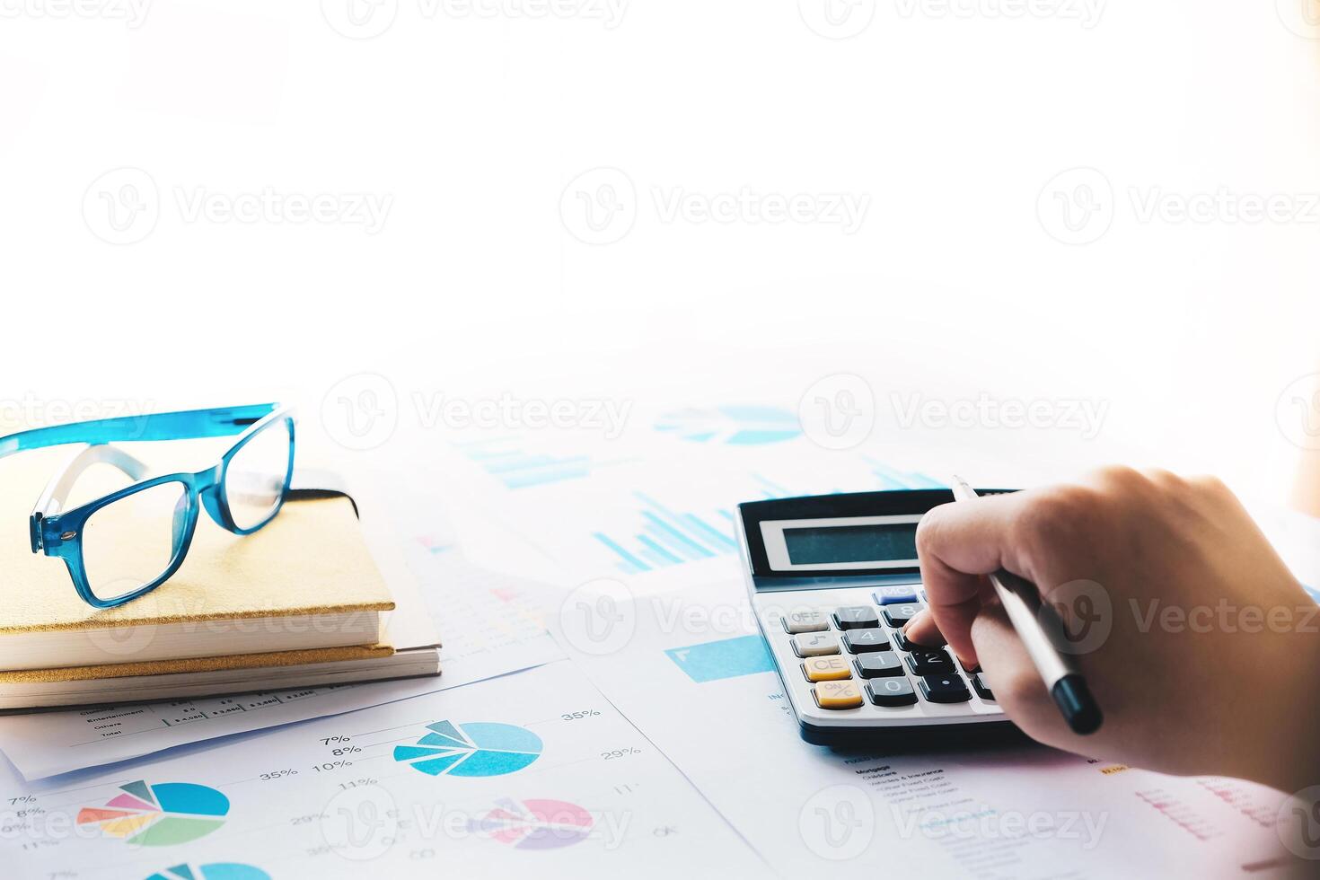 Close up of female accountant or banker making calculations. Savings, photo