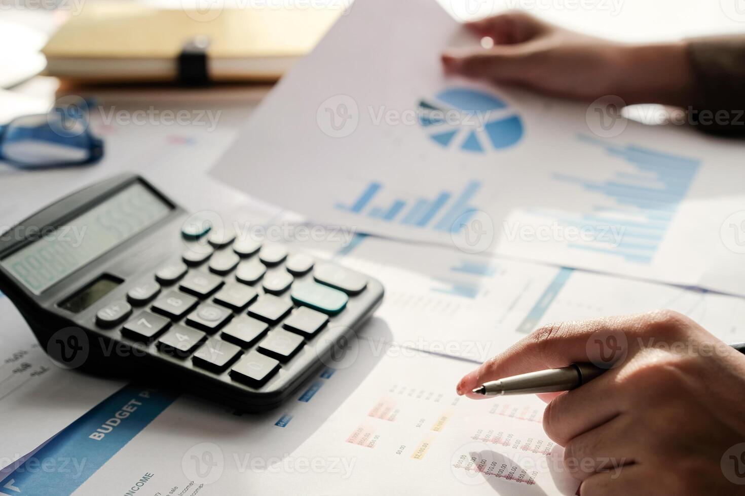 business woman working on desk office with using a calculator photo