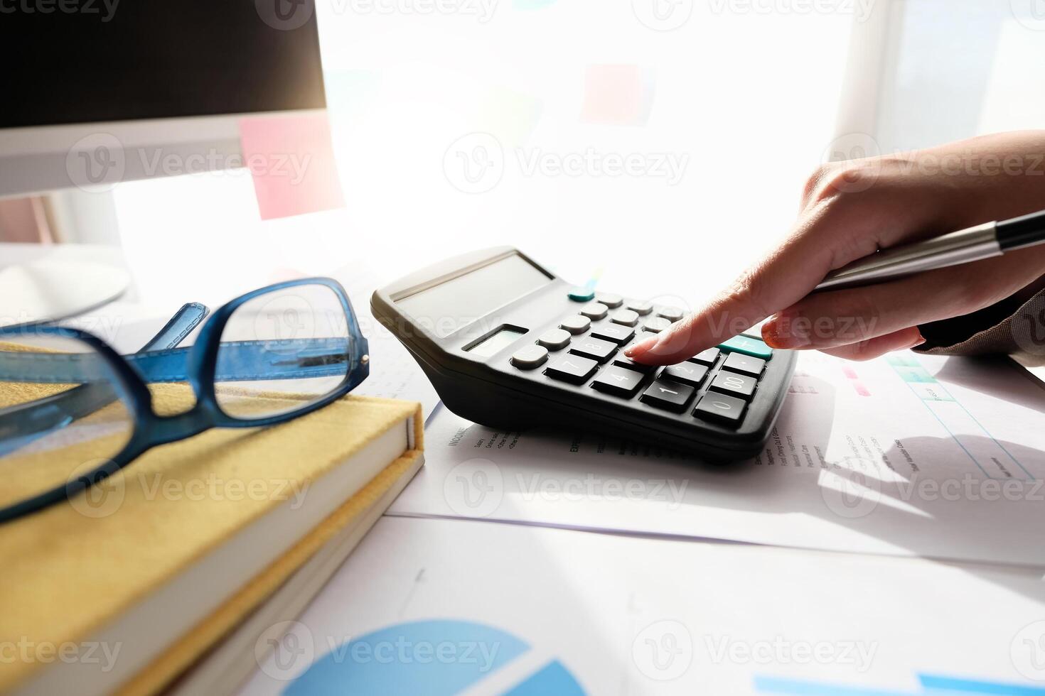 Close up Accountant using calculator for calculating financial expense at home office photo