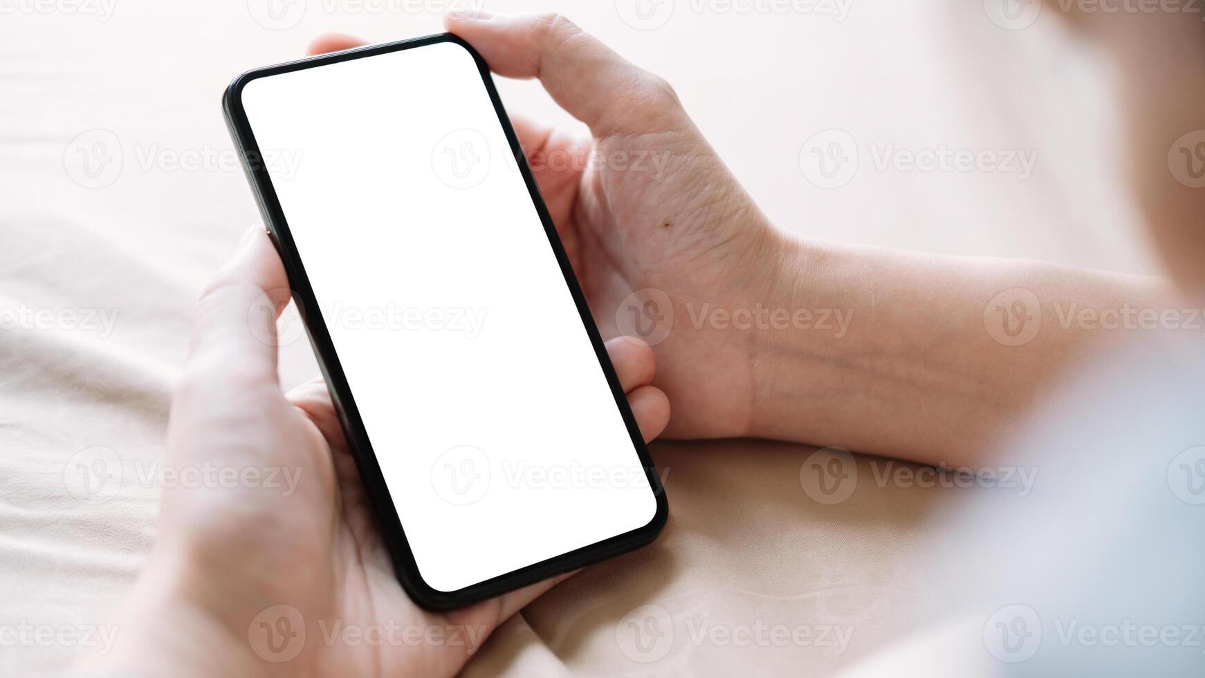 Close up Woman hand Using a Smart Phone with white screen at home photo