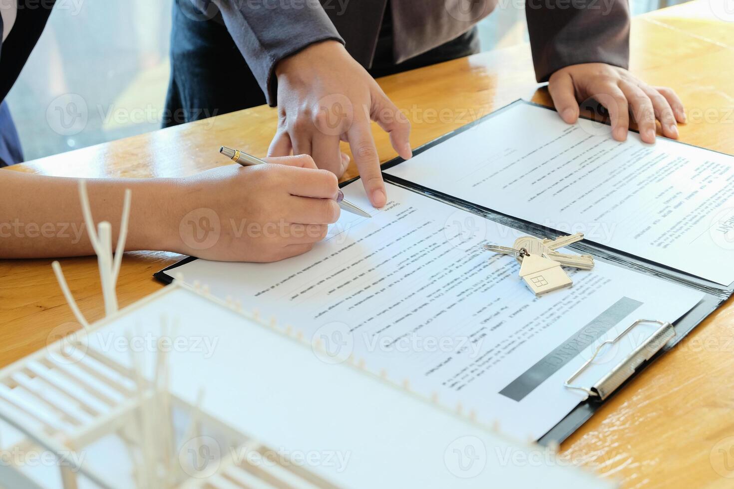 Real estate agent offer hand for customer sign agreement contract signature for buy or sell house. photo