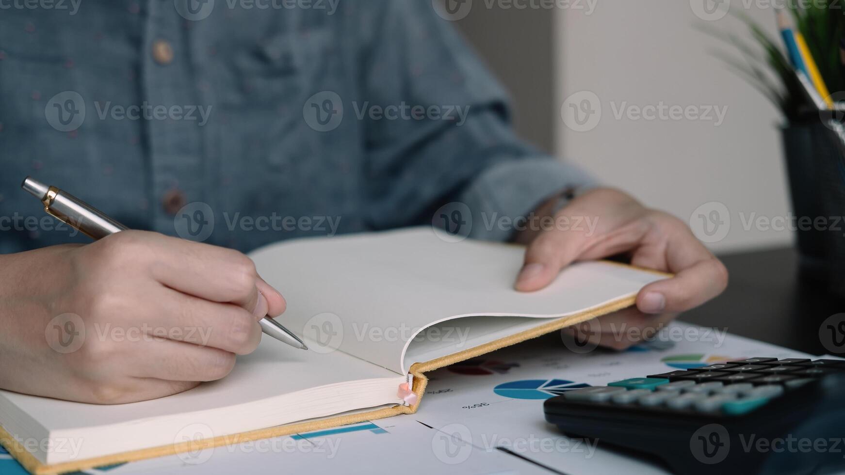 A woman using note some data on notepad for financial calculating photo