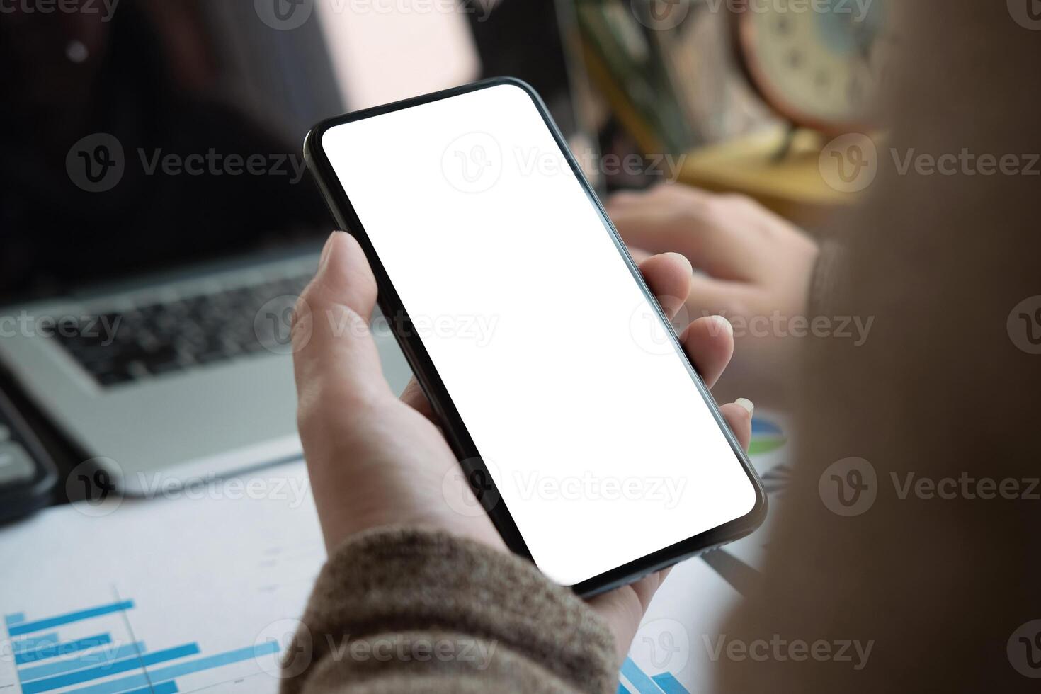Woman using smartphone with blank screen for business financial work at home photo