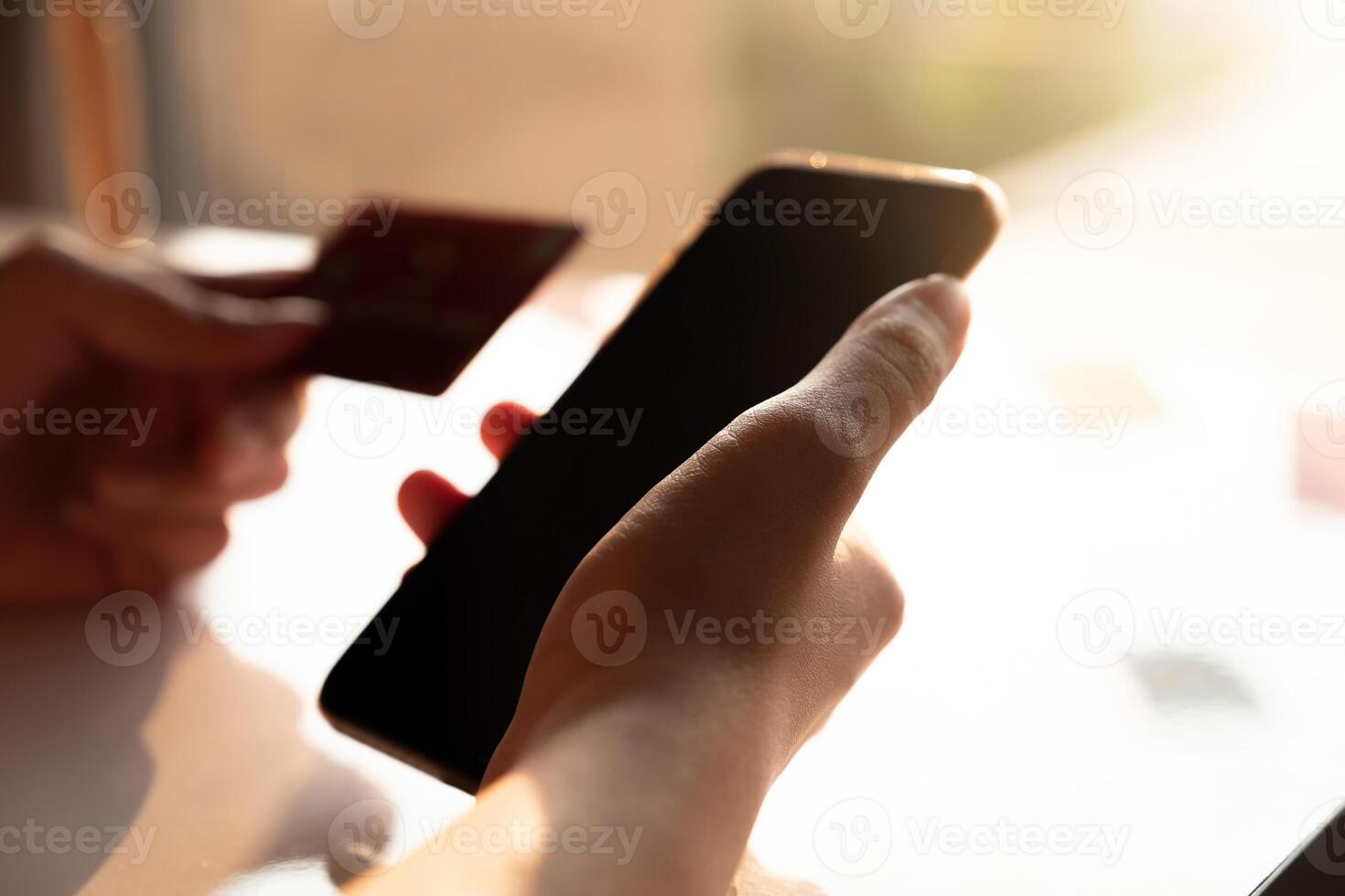 Online payment, Man's hands holding a credit card and using smart phone for online shopping photo