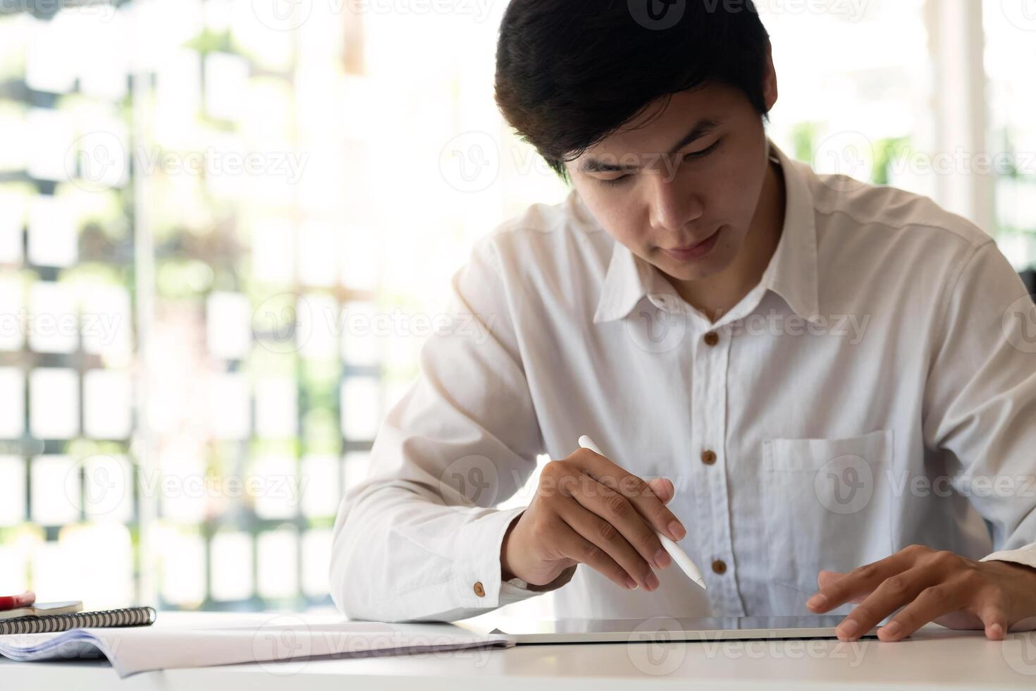 Young business using smart tablet for analysis financial report photo