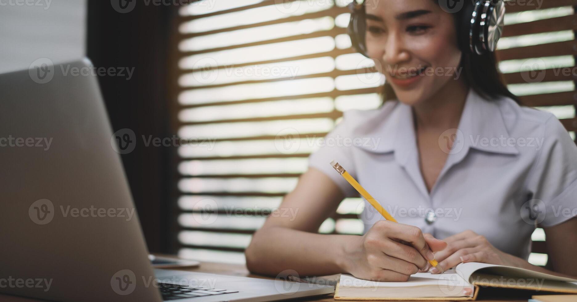 Smiling girl student wear wireless headphone study online learn language listen lecture photo