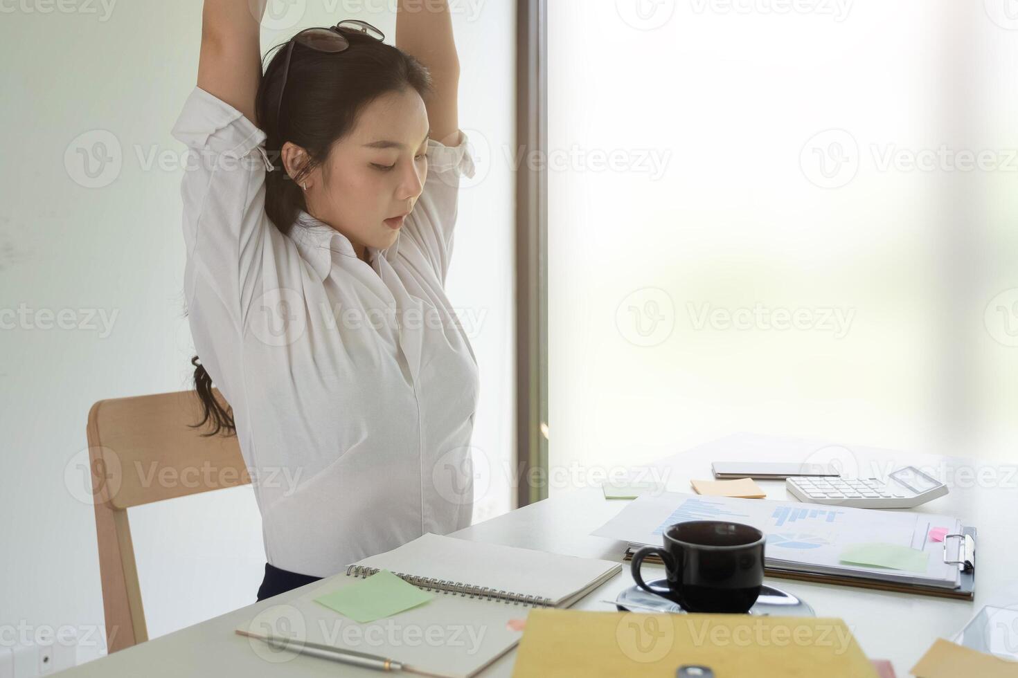 Businesswoman relaxing at comfortable in office hands behind head, happy woman resting in office satisfied after work photo