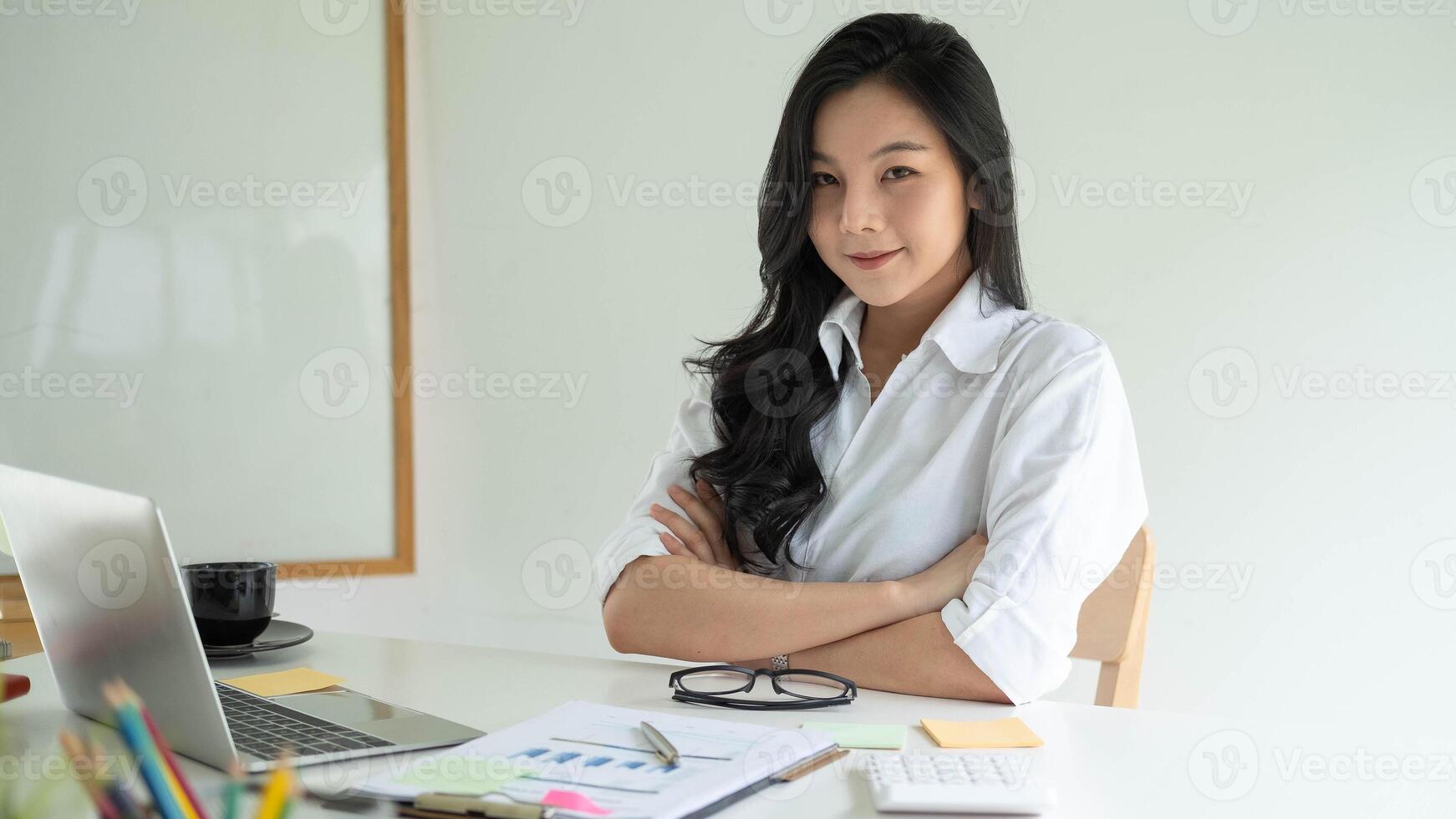 Portrait Of Attractive Asian young business entrepreneur woman working at modern office photo