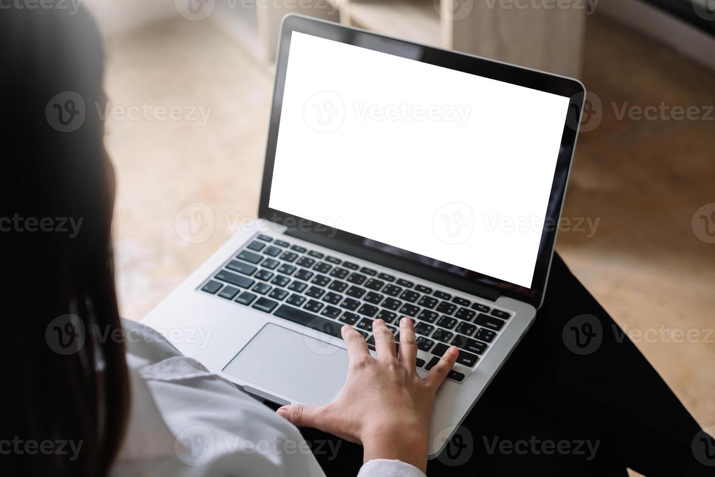 young woman working with laptop computer at home, empty screen display photo