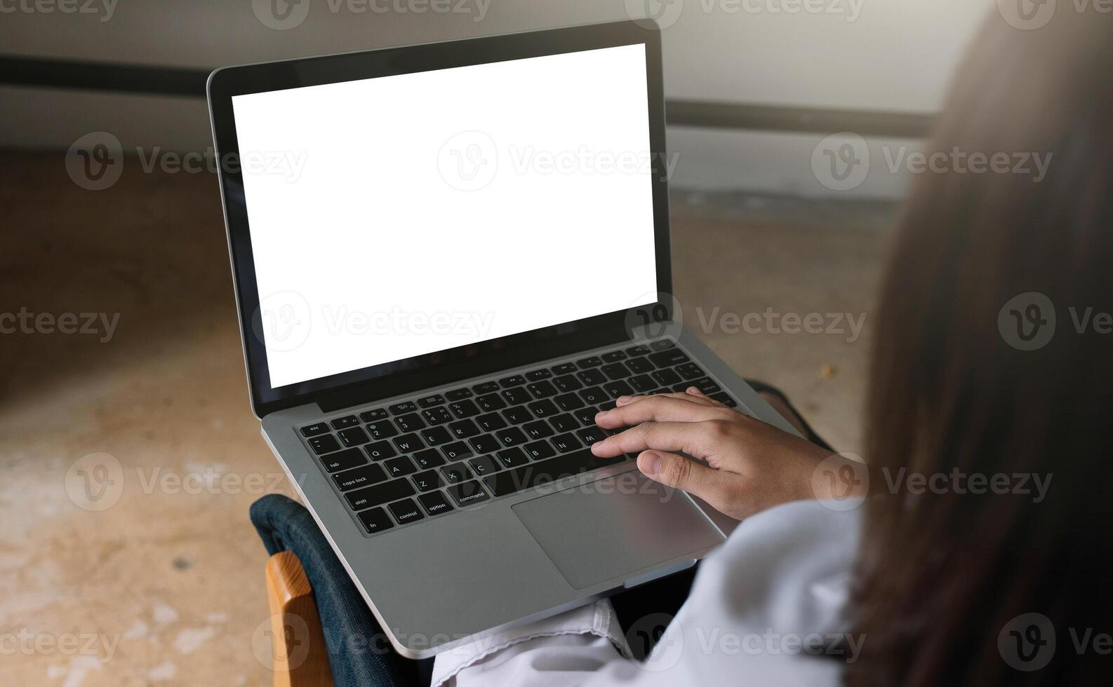 young woman working with laptop computer at home, empty screen display photo