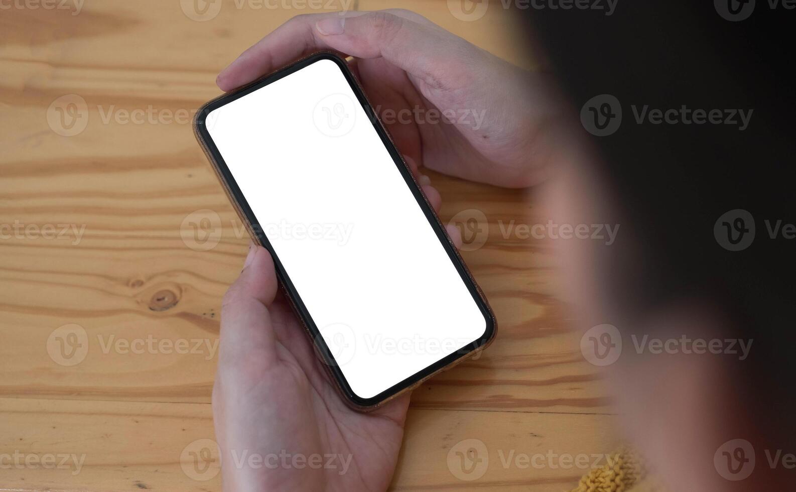 Woman using smartphone with blank white screen photo