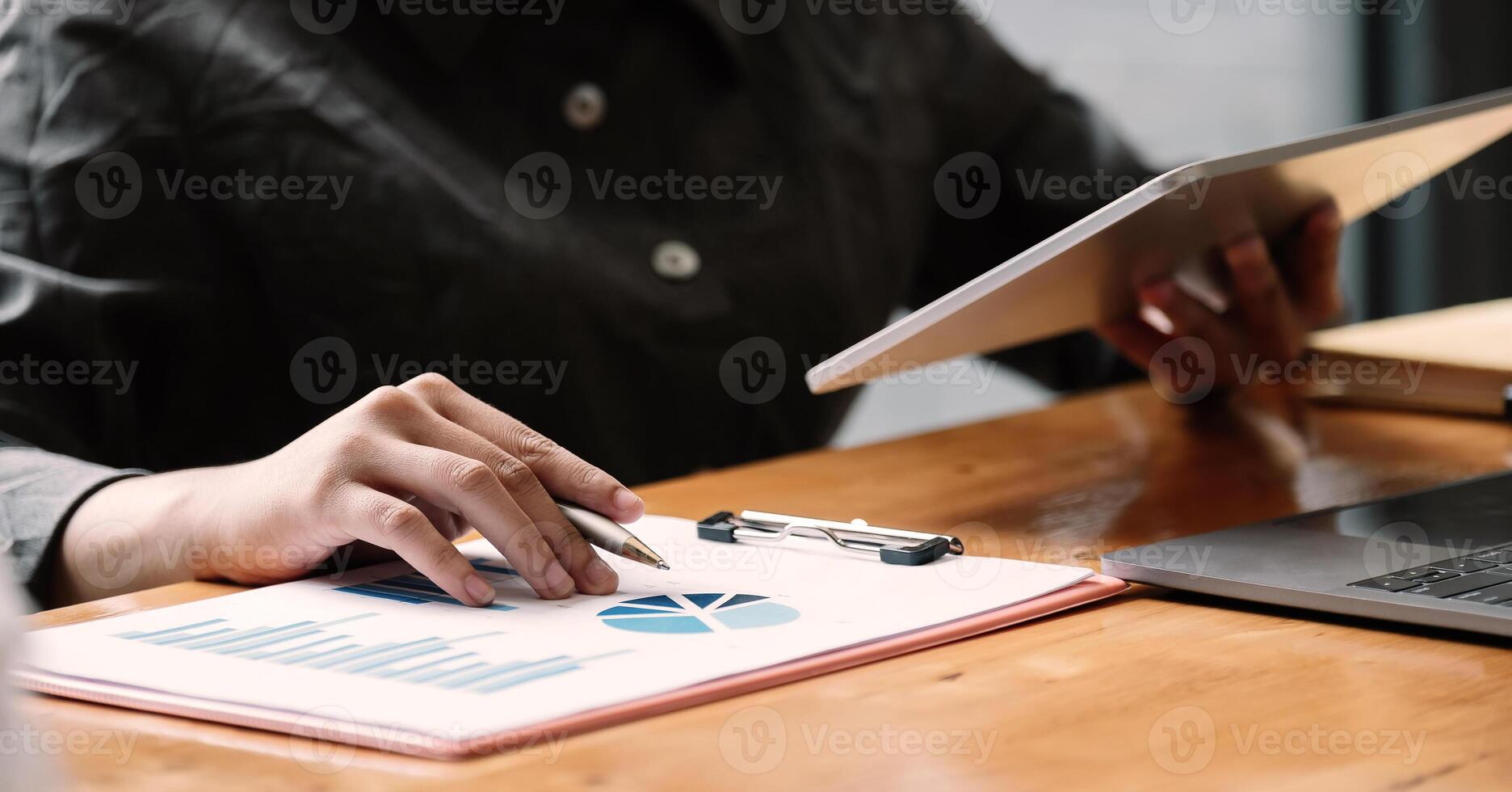 Business woman using tablet computer for analysis financial report photo