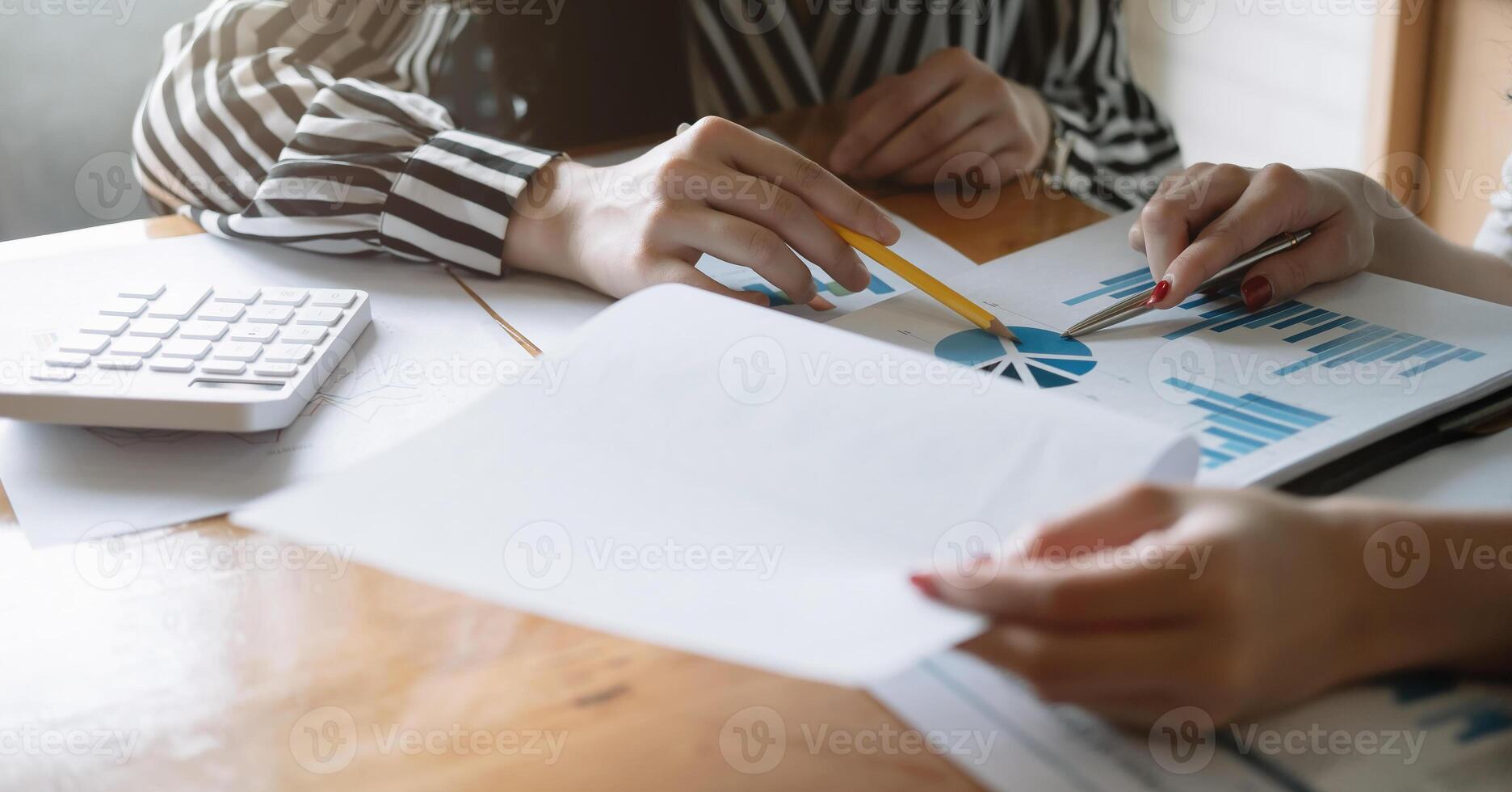 Closeup Group of Business analyzing investment graph from financial report and meeting brainstorming discussing plan photo