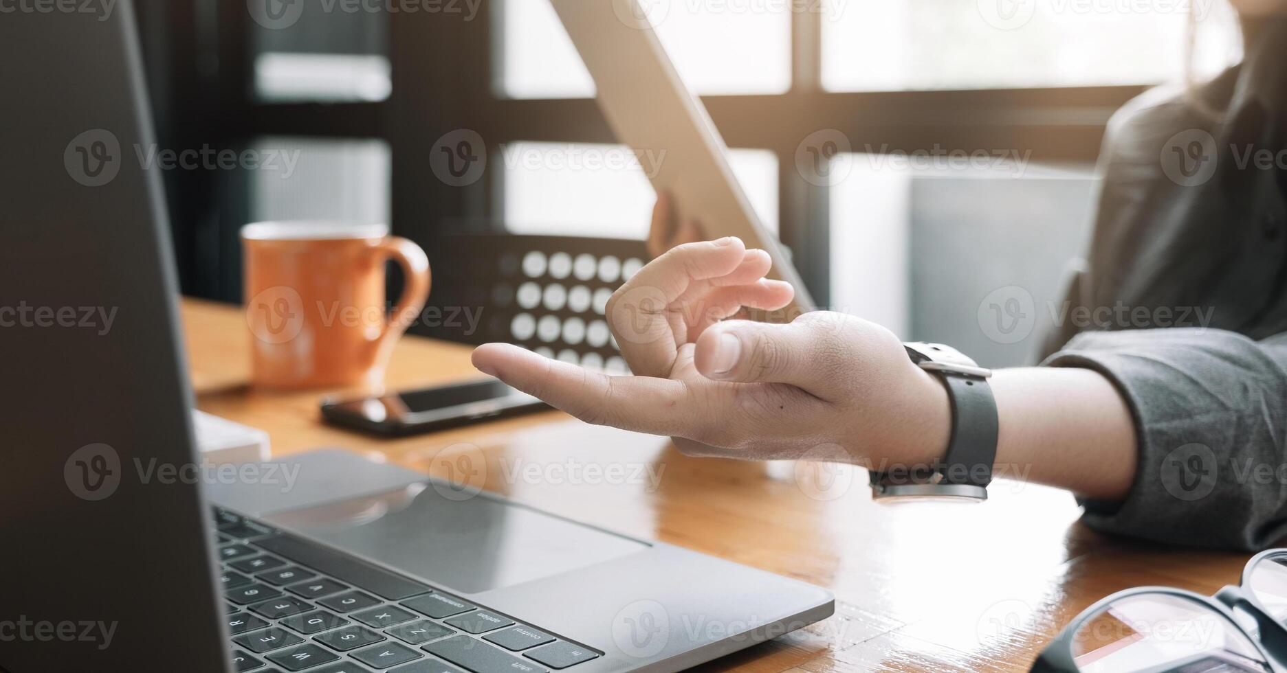 Young woman use tablet computer for business analyze and hand potinting on computer photo