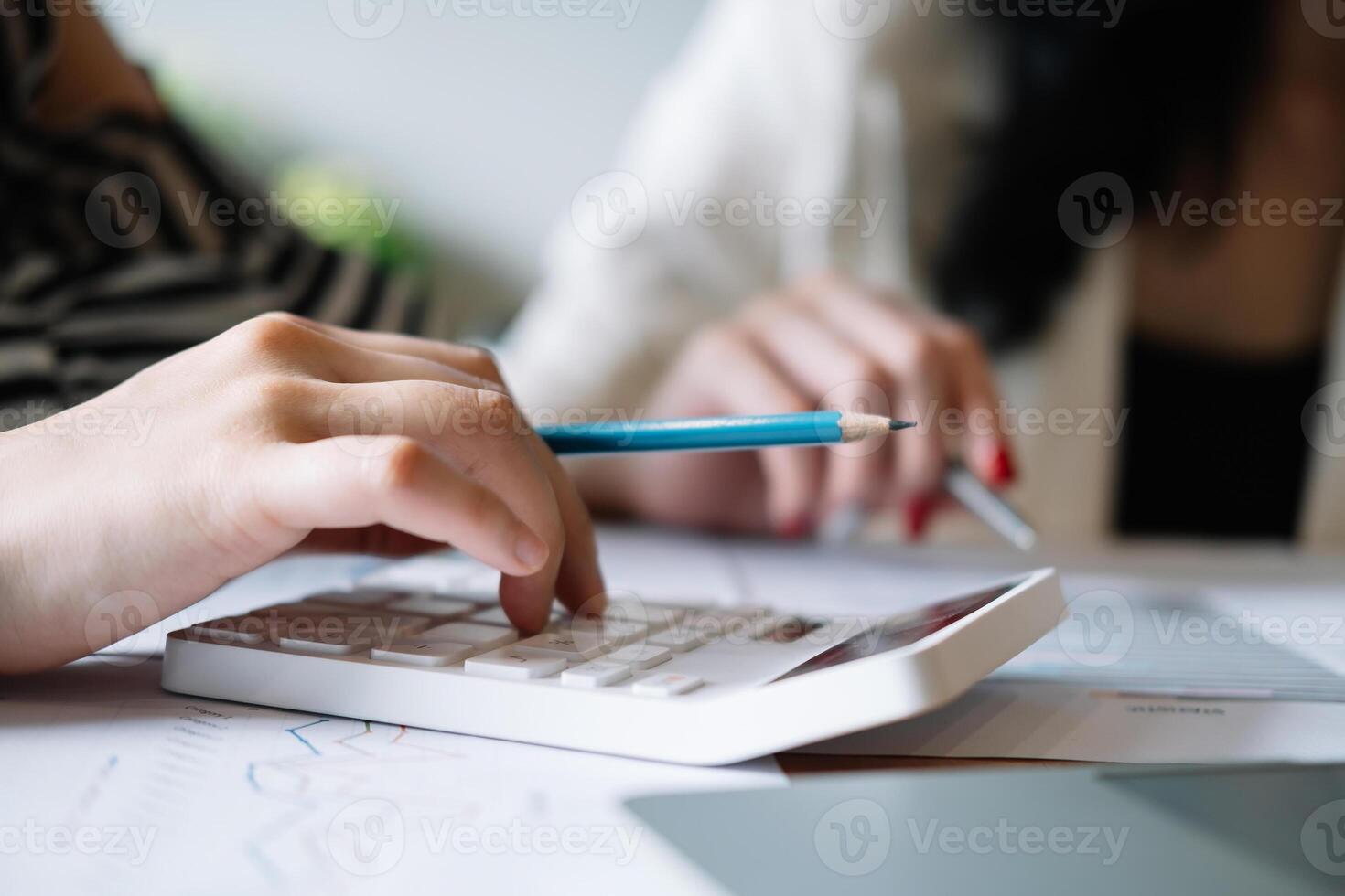 Closeup business people using calculator for calculate business data report in the office photo
