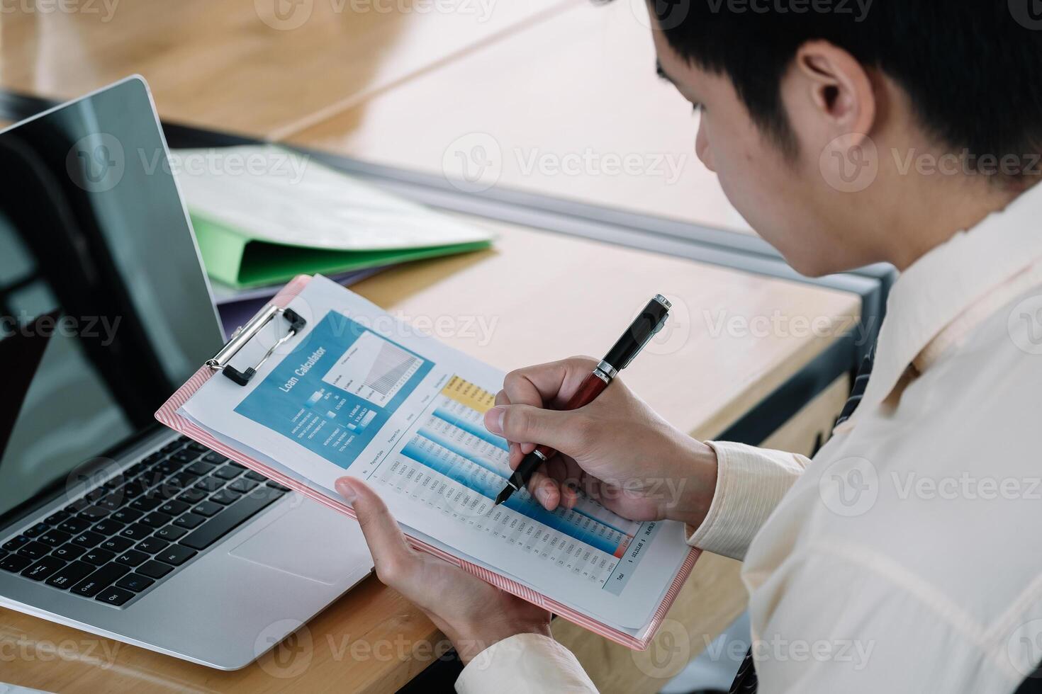 Businessman discussing the charts and graphs showing the results at office photo