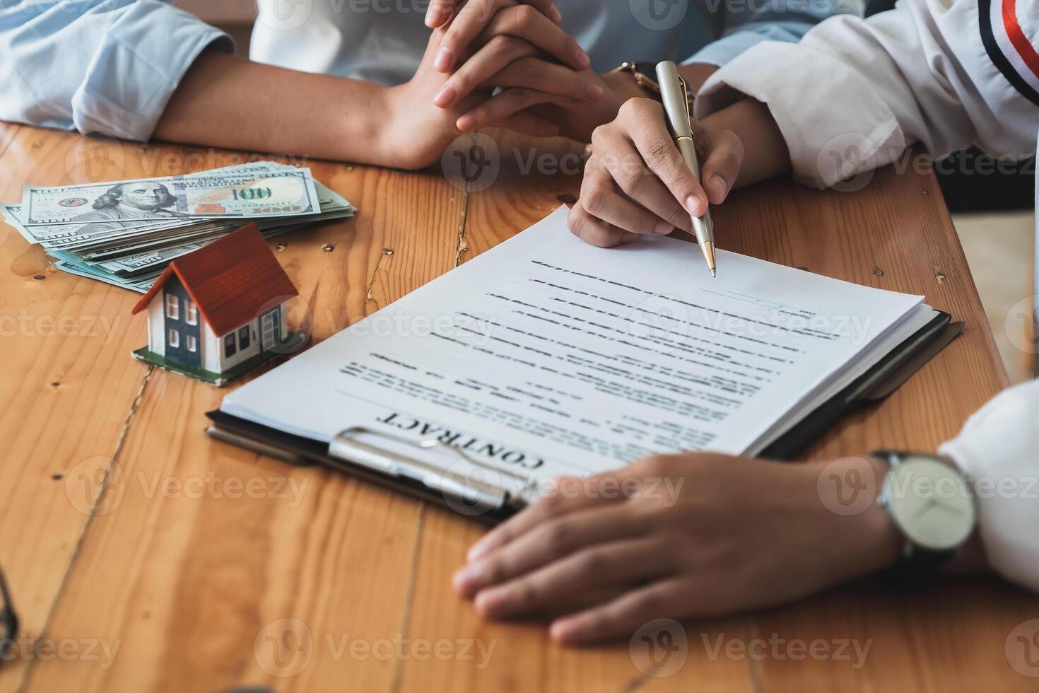 Real estate agents agree to buy a home and give keys to clients at their agency's offices. Concept agreement photo