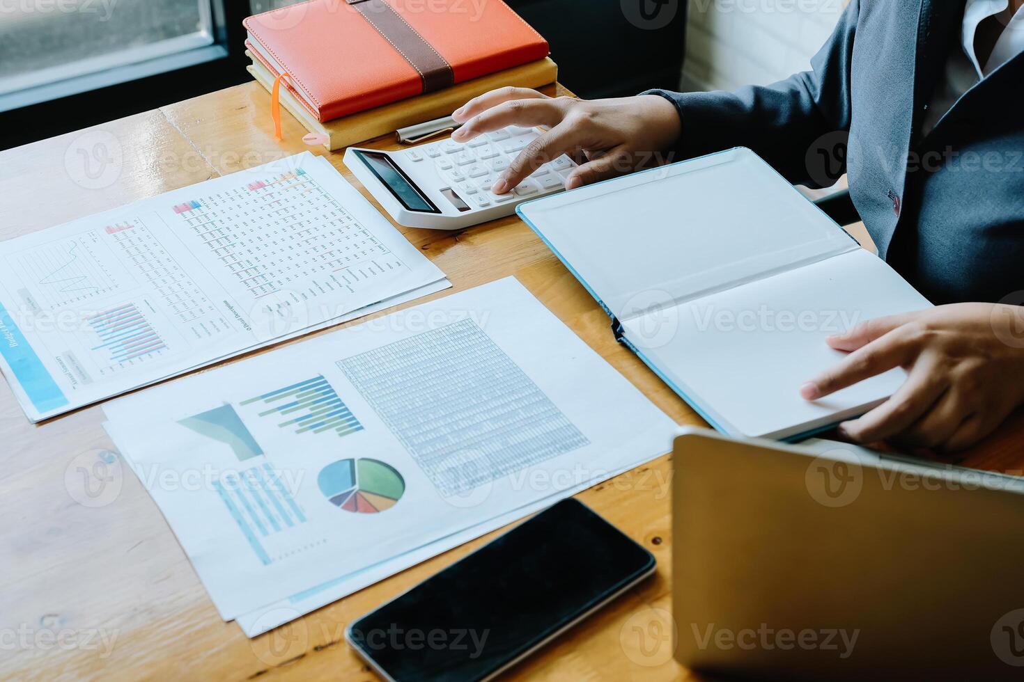 Business woman using calculator for do math finance on wooden desk in office and business working background, tax, accounting, statistics and analytic research concept photo