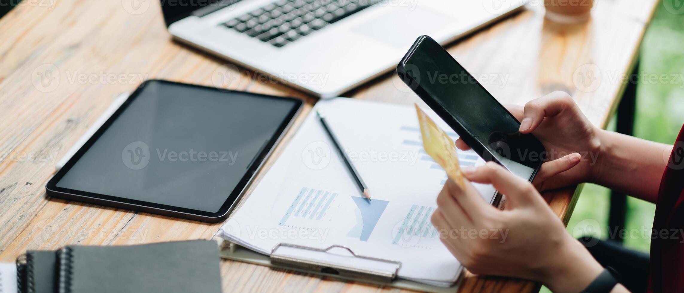 Woman using credit card and mobile phone for online shopping and internet payment via mobile banking application photo