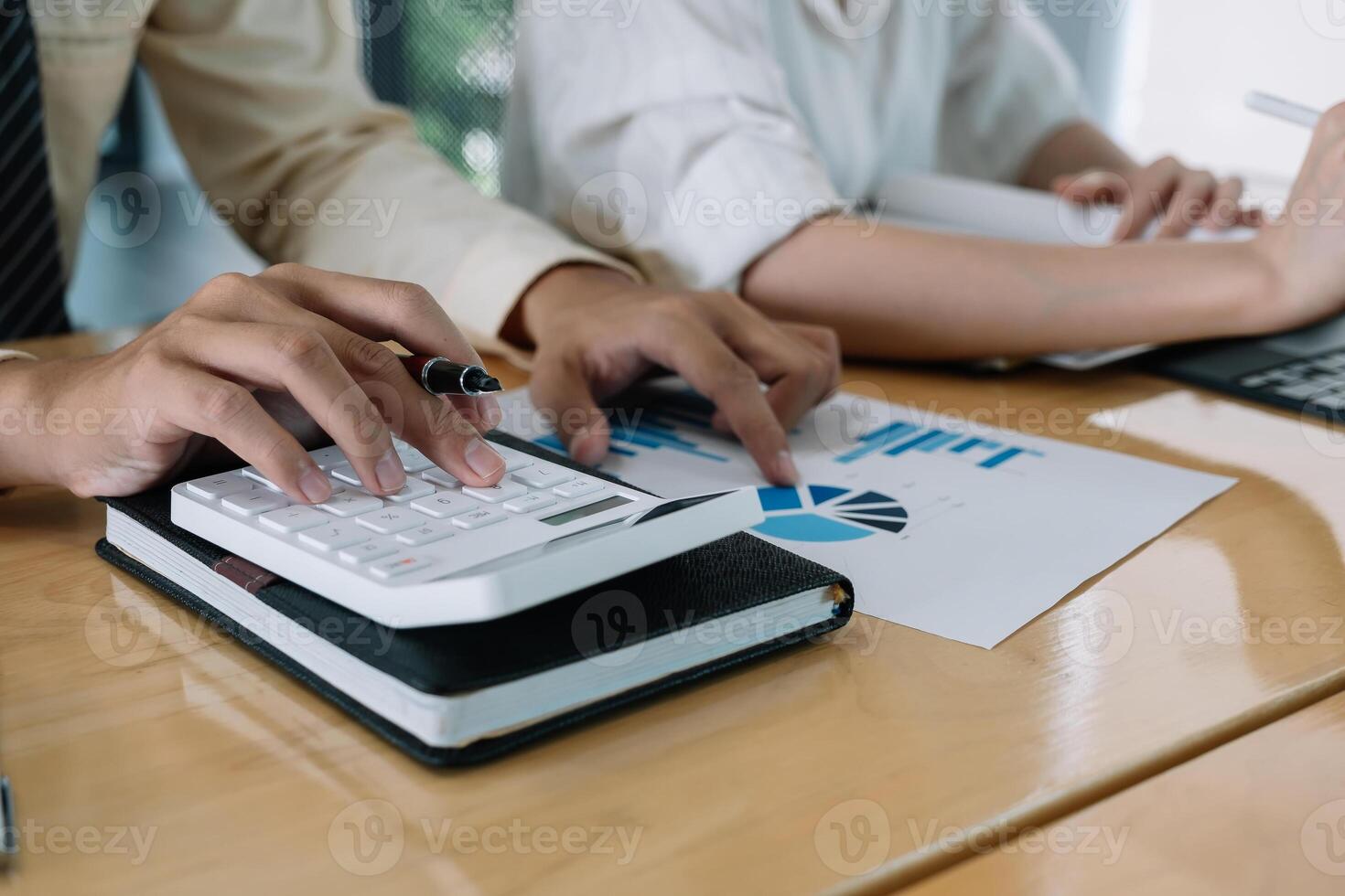 Businessman using calculator for do math finance on wooden desk in office and business working background, tax, accounting, statistics and analytic research concept photo