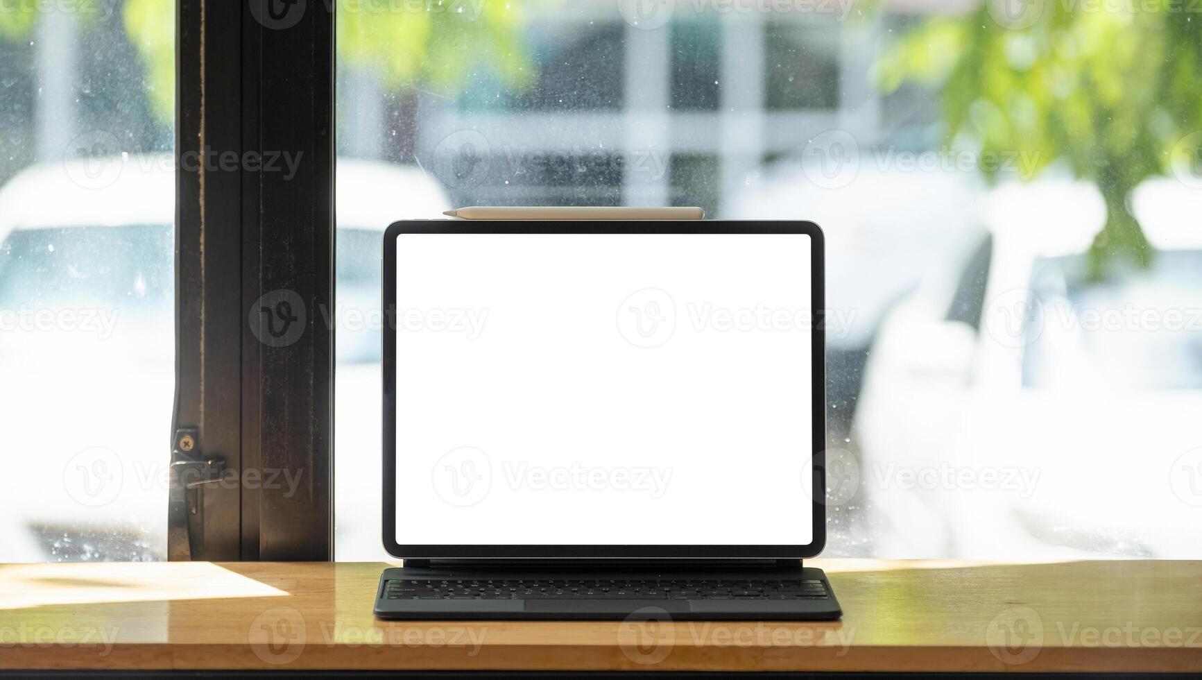shot of digital tablet with blank white screen on wooden desk photo