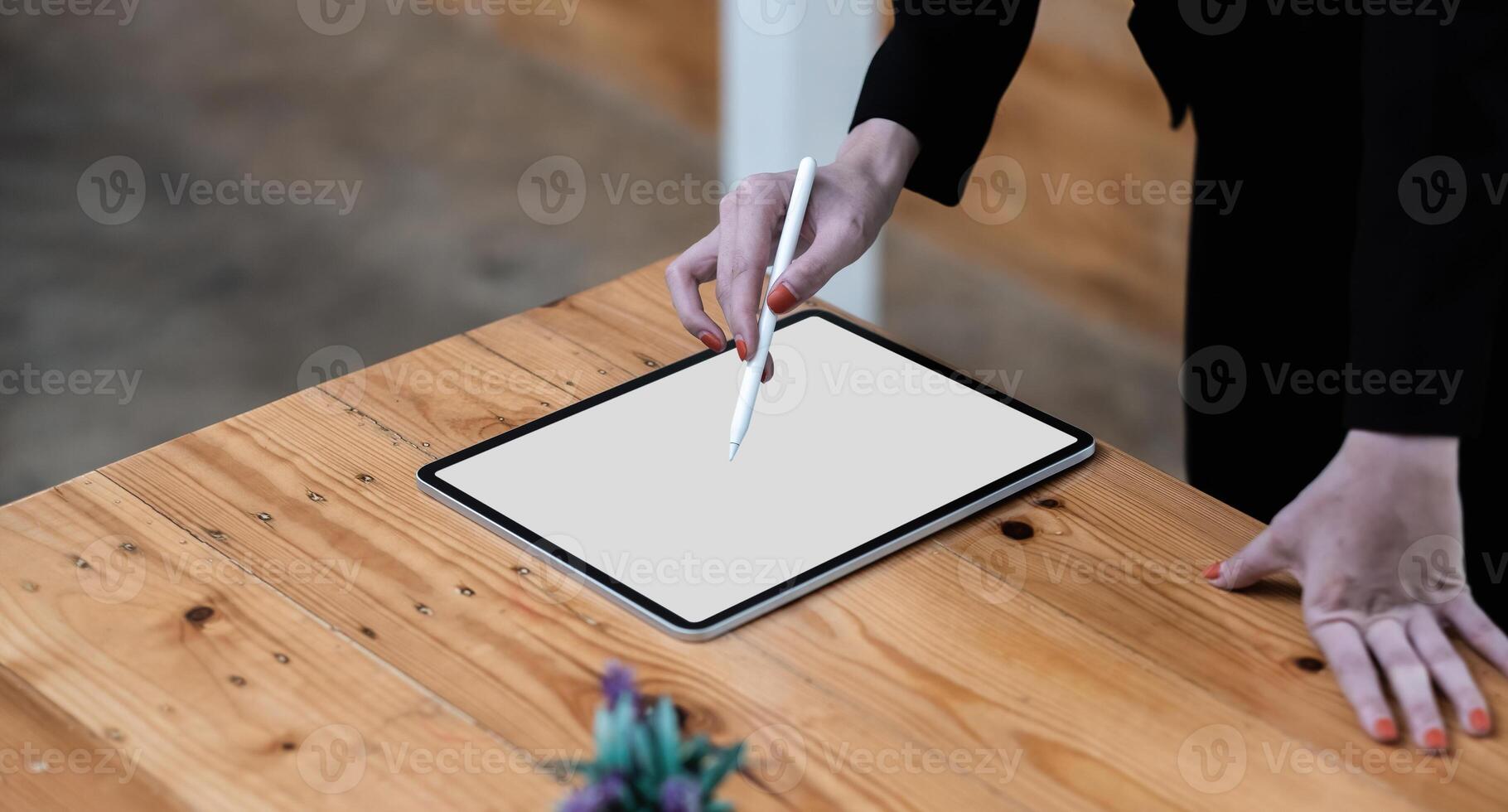 Close up hand of business woman working desk drawing on a white blank screen computer tablet photo