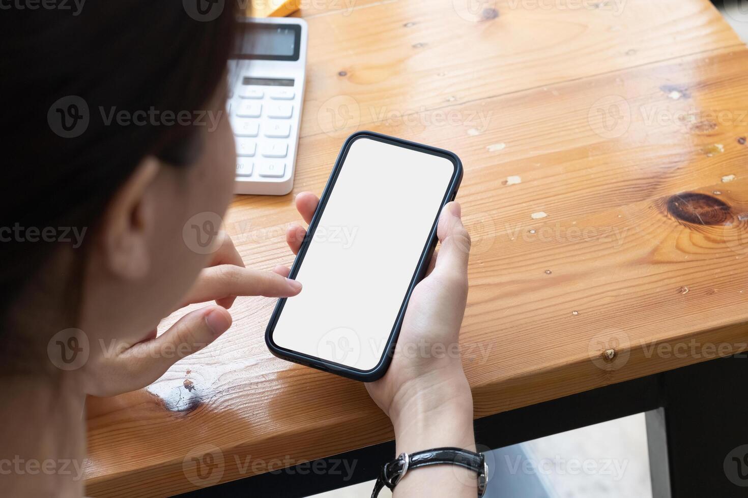 Young girl hands holding mobile phone touching finger mockup white blank display, empty screen for social media app ad at home. Mobile application tech concept photo