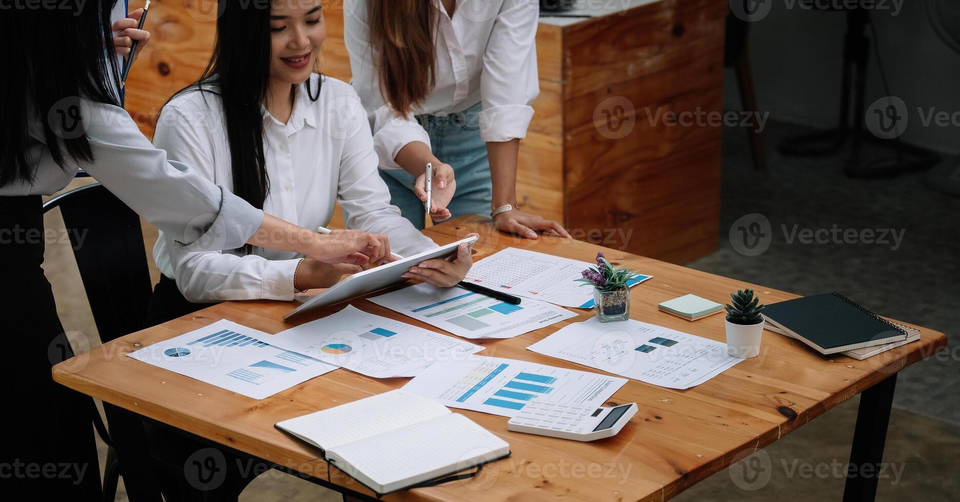 Business asian team collaboration discussing working analyzing with financial data and marketing growth report graph, presentation and brainstorming to strategy planning making profit of company photo