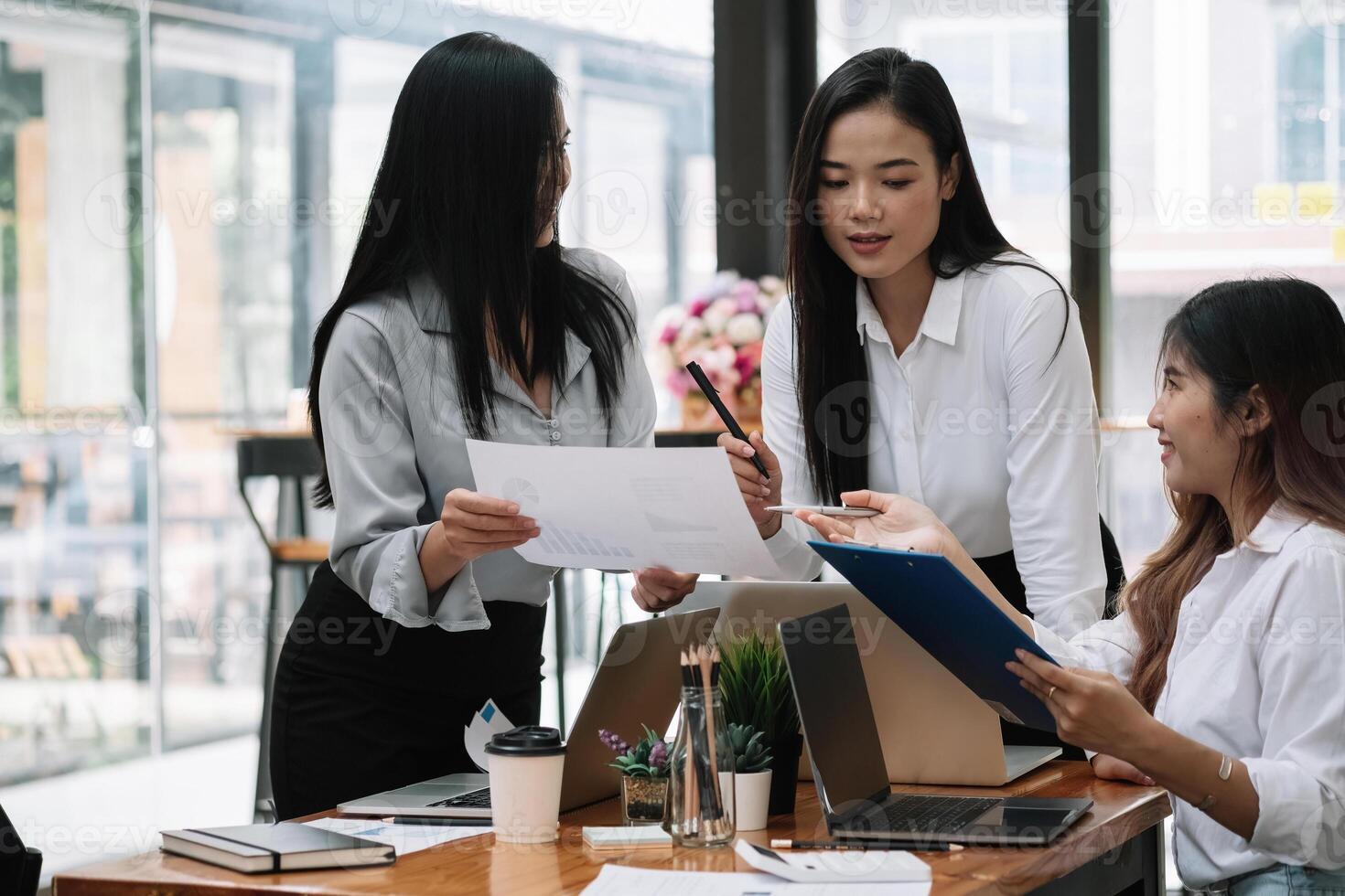 Business asian team discussing working analyzing with financial data and marketing growth report graph in team, presentation and brainstorming to strategy planning making profit of company photo