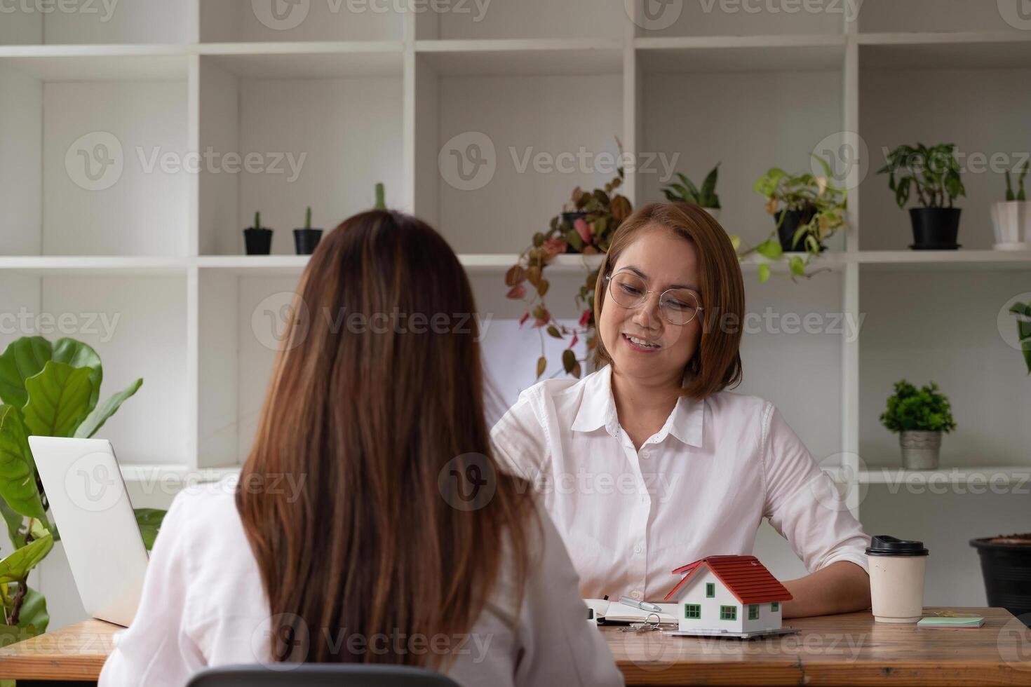 real estate agent meeting with client ready to sign contract, concept for real estate, moving home or renting property photo