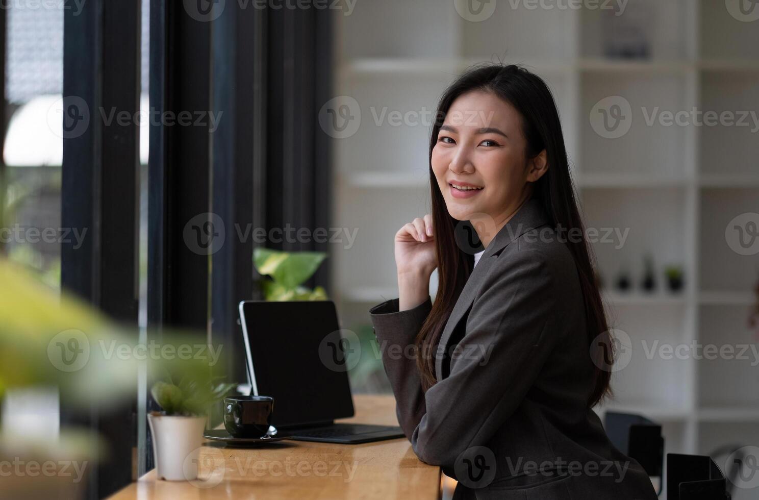 Portrait of smiling beautiful business asian woman working in modern office desk using tablet laptop computer, Business people employee freelance online marketing e-commerce telemarketing concept photo