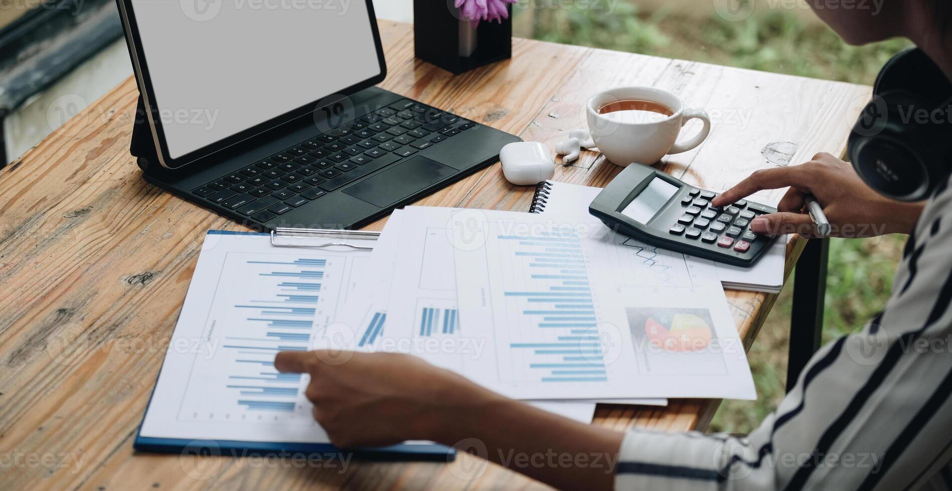 Close-up calculator to calculate the company's financial results On the wooden table in the office and business work background, tax, accounting, statistics, and analytical research concept photo