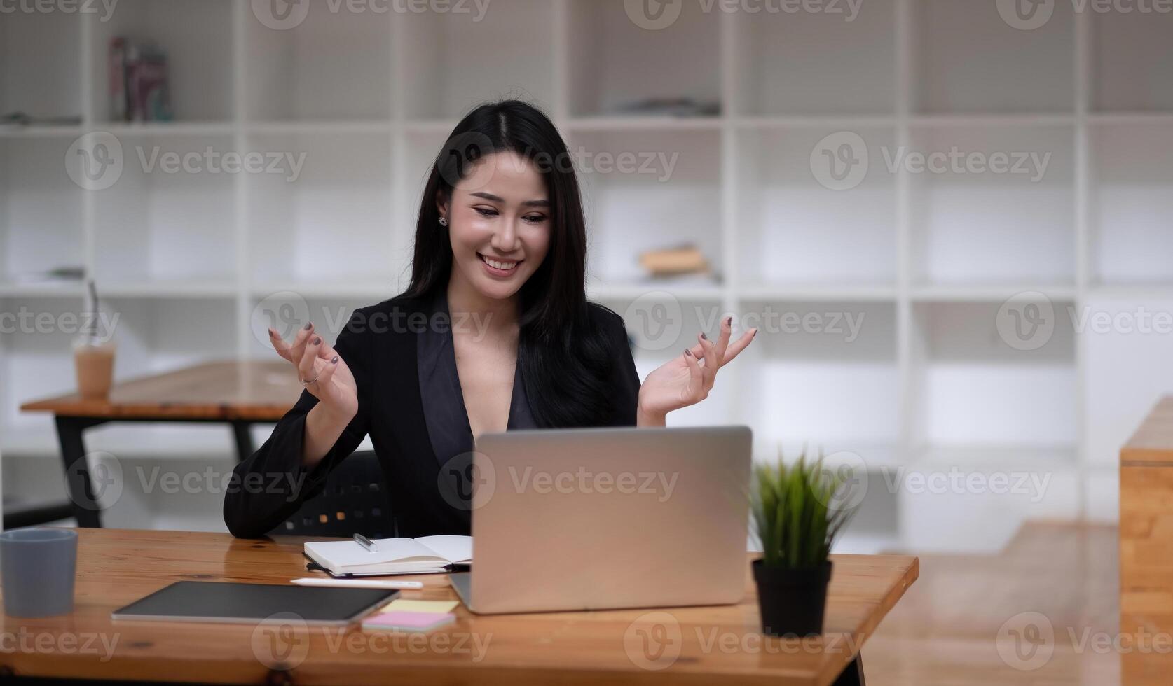 Happy asian woman communicate by call on computer working from home. Smiling businesswoman talking by conference, online virtual meeting using computer photo